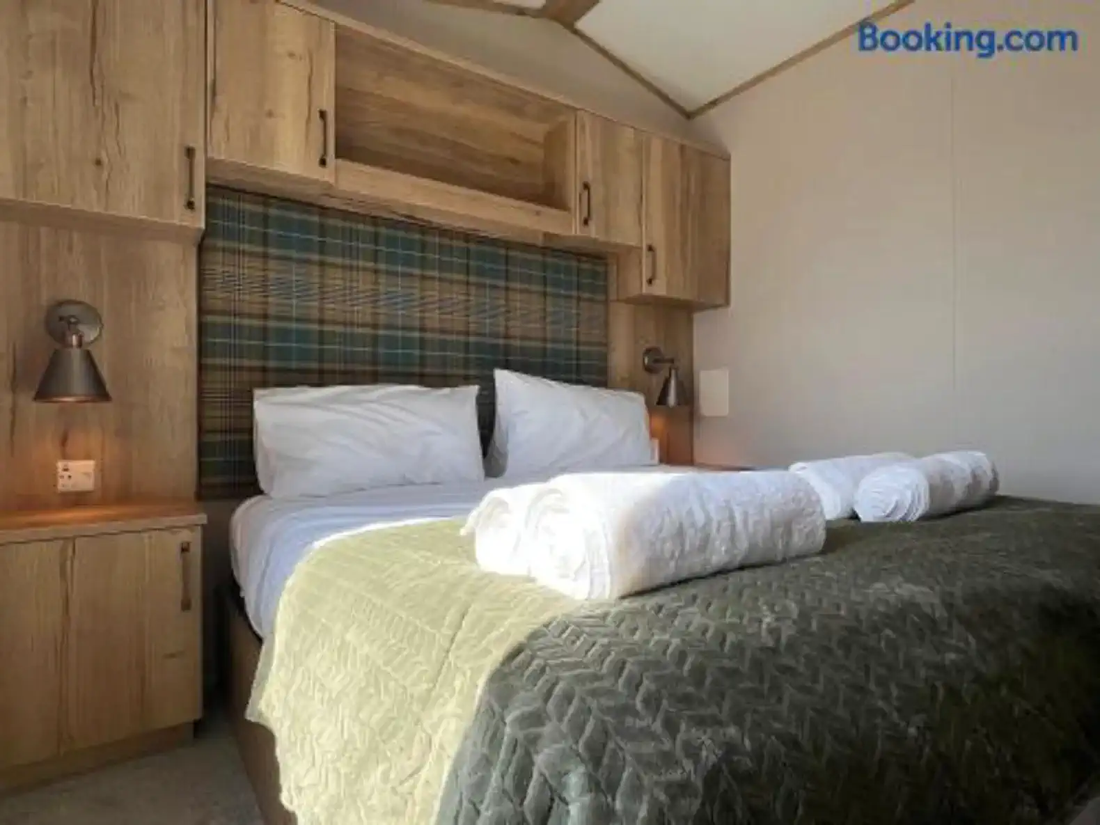 Cozy master bedroom with wooden cabinetry and plush bedding