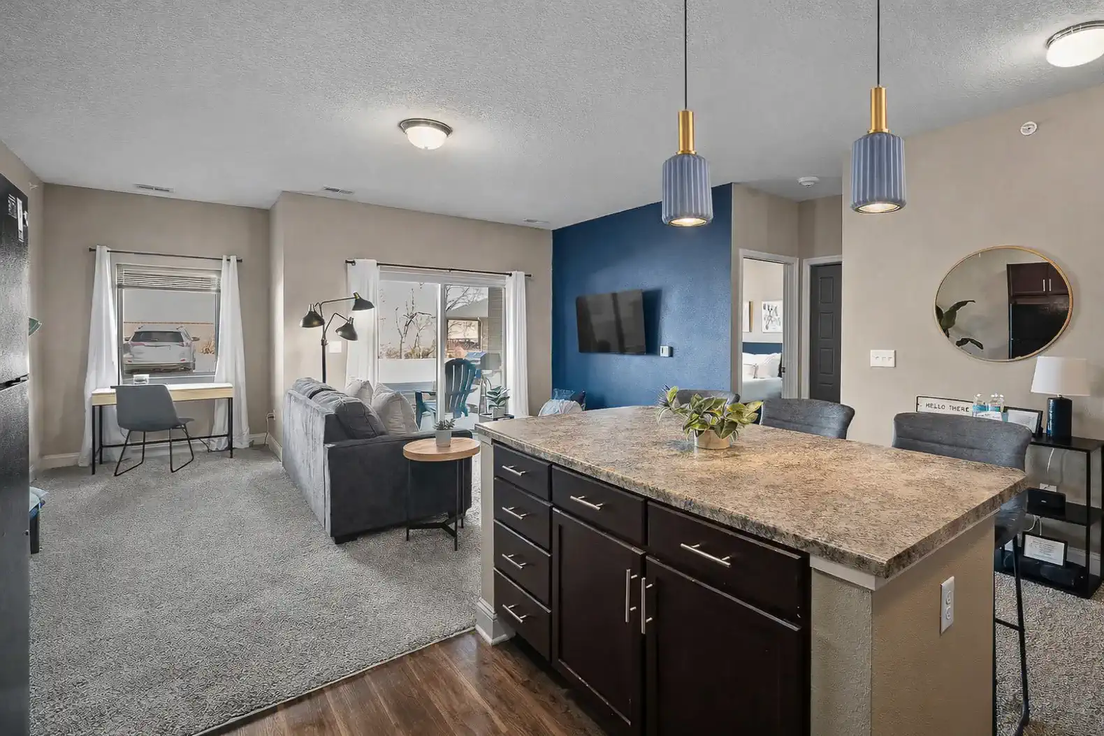 Bright, open-concept living and kitchen space with upgraded pendant lighting, modern finishes, and plenty of room to relax or work. Designed for comfort, flow, and everyday living with easy access to the private patio just beyond.