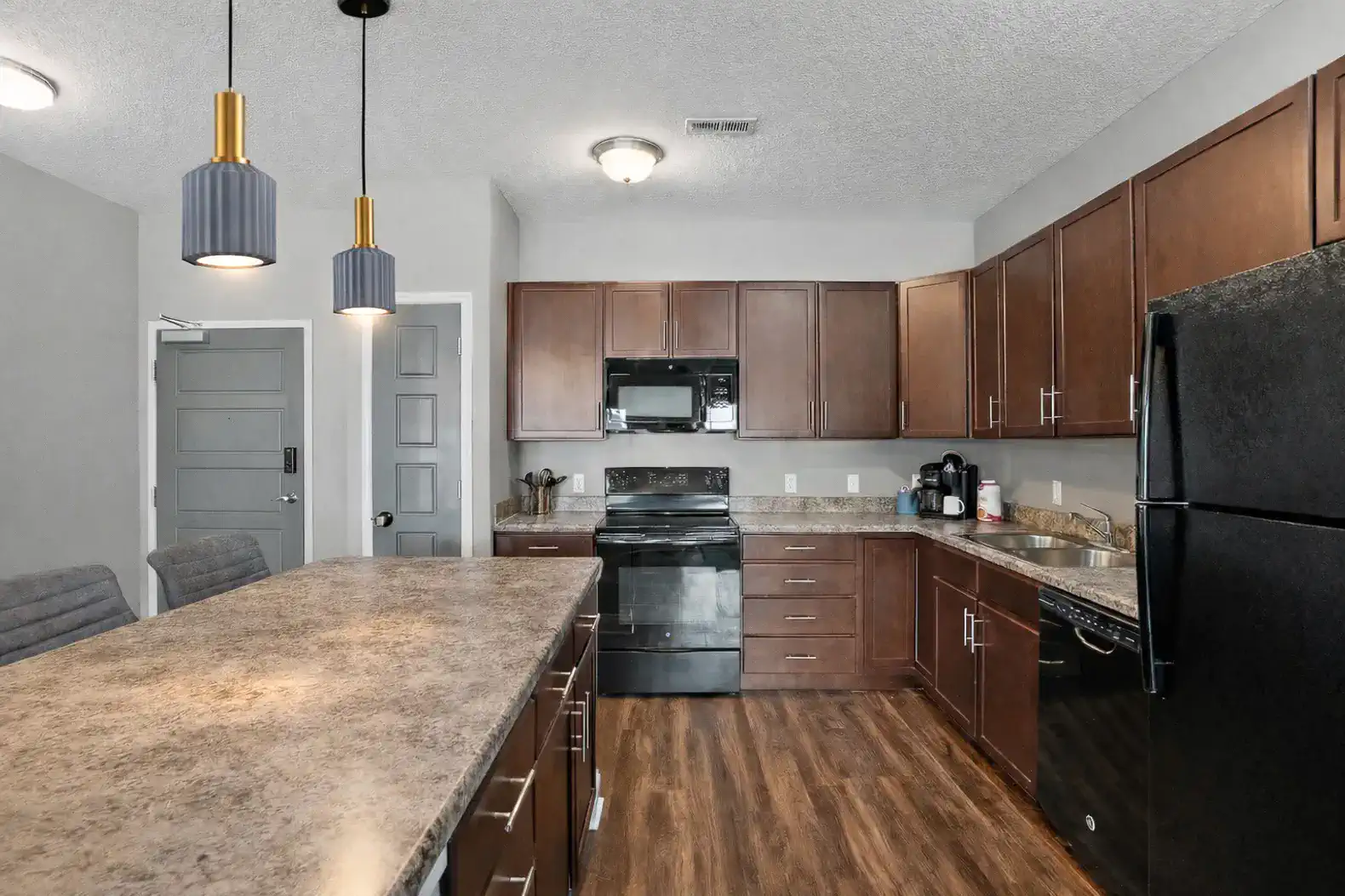 Open, functional kitchen with generous counter space, modern appliances, and a large island that works just as well for quick meals as it does for spreading out and getting things done. Clean lines, solid storage, and easy flow into the living area m
