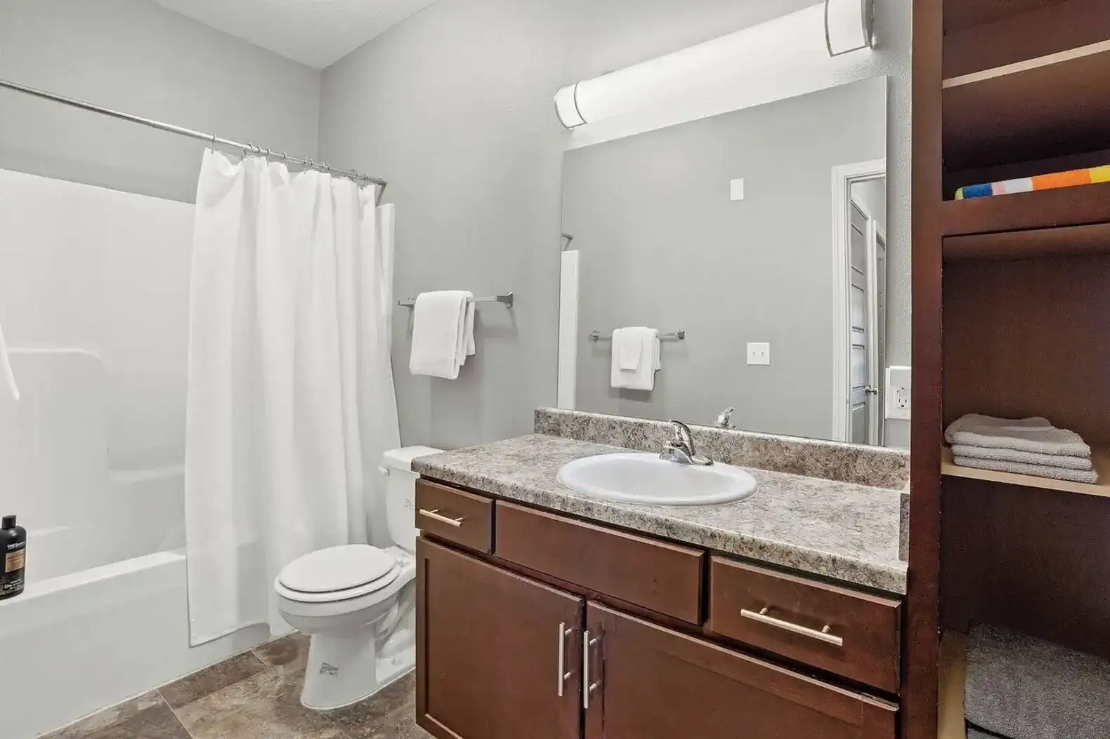 Clean, simple, and functional bathroom with a full tub/shower combo, spacious vanity, and plenty of storage. Fresh towels and essentials are provided, making it easy to settle in whether you’re here for a quick stay or a longer visit.