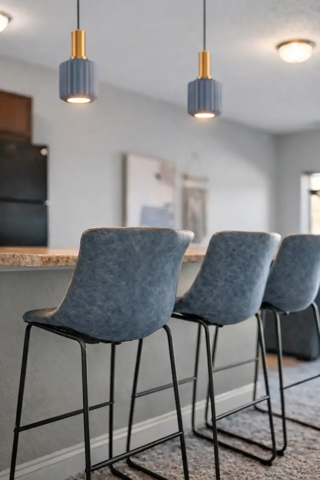 Modern breakfast bar with plush stools and chic pendant lighting