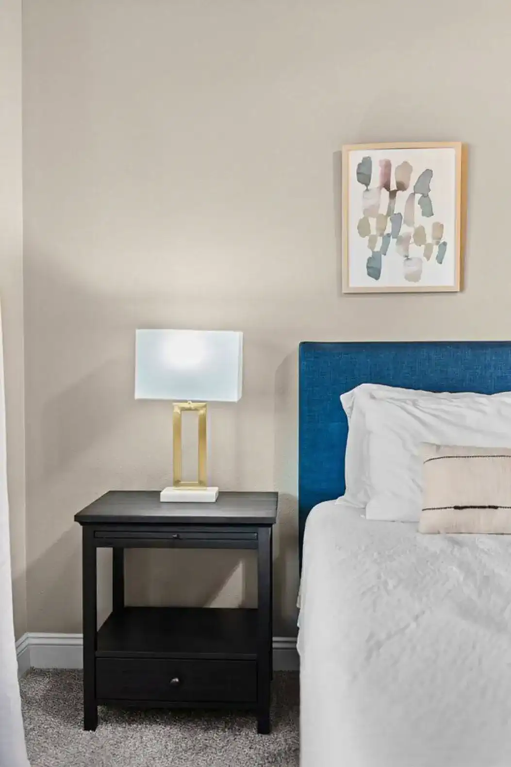 Clean, modern bedroom details with updated furnishings, soft lighting, and thoughtful decor—designed to feel calm, comfortable, and intentionally styled for a relaxing stay.