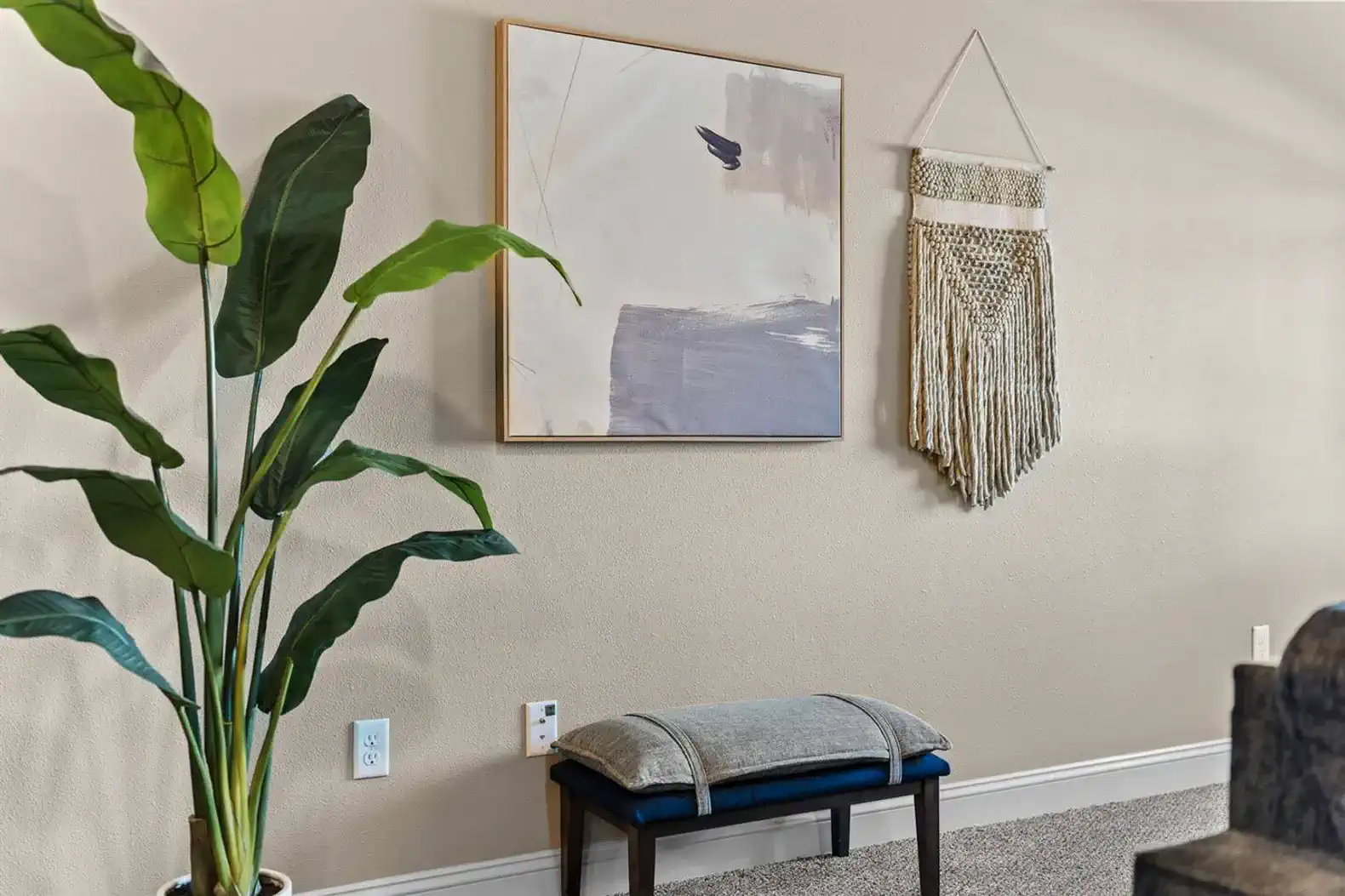 Thoughtfully styled accents, artwork, and greenery add warmth and personality—finishing touches that make the space feel curated, comfortable, and far from generic.