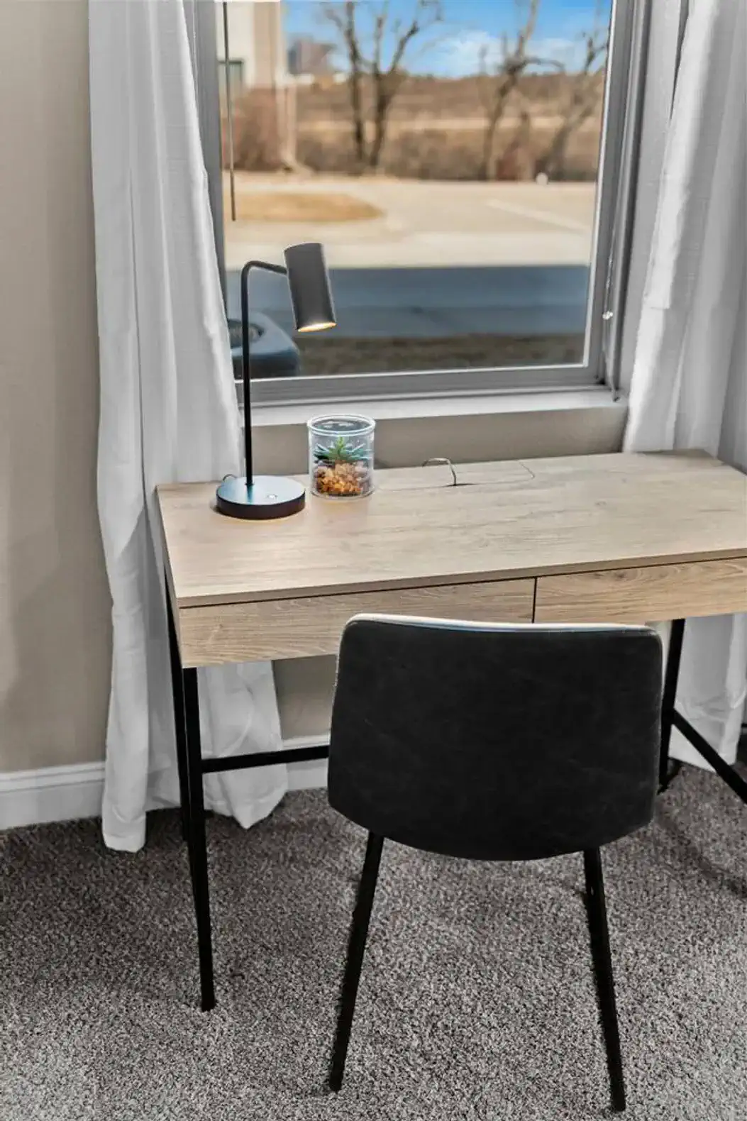 Dedicated workspace with a clean desk, comfortable chair, and natural light—ideal for remote work, planning your day, or catching up on emails in a quiet setting.