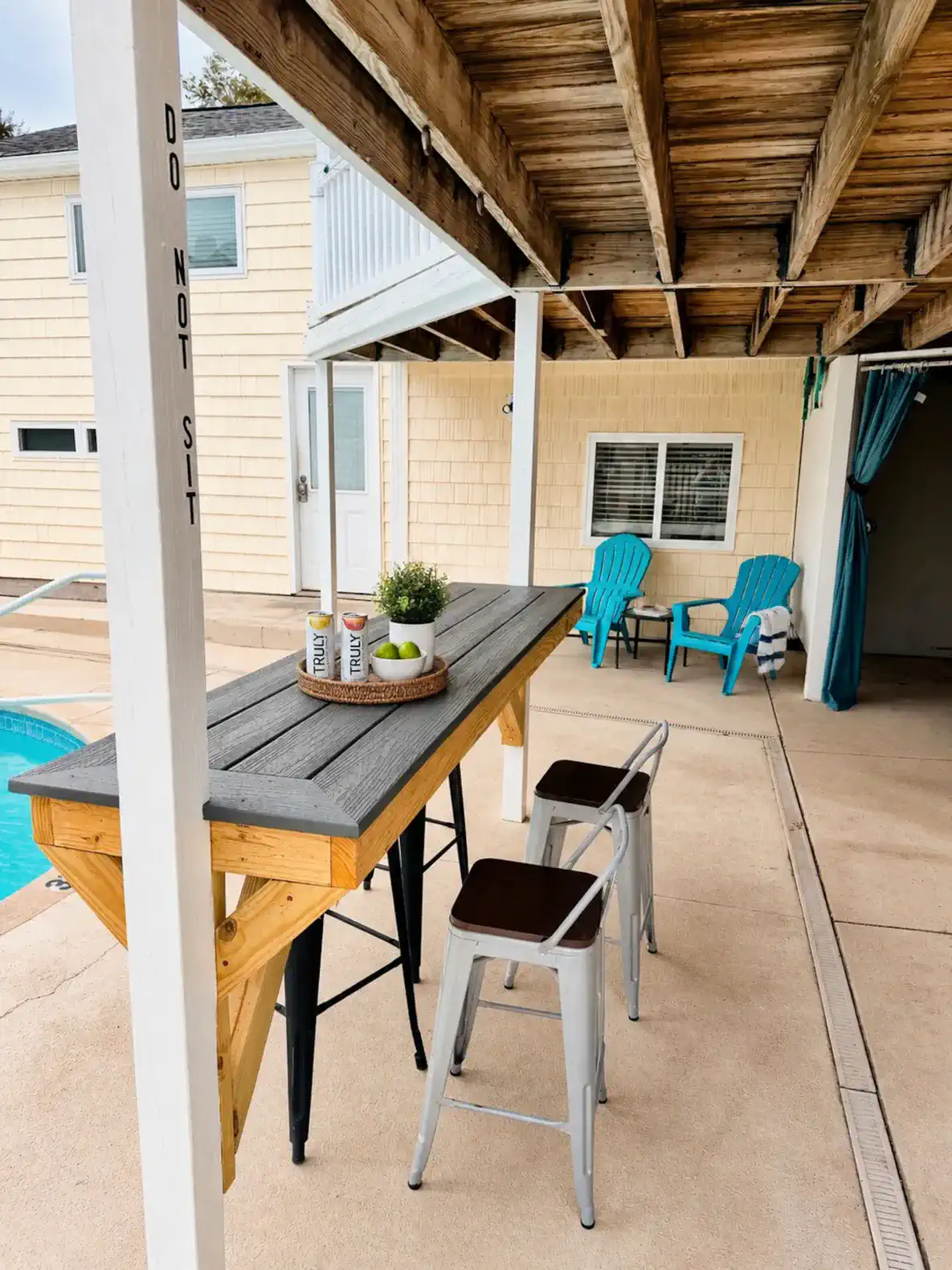 Outdoor bar area with seating near the pool and beach access