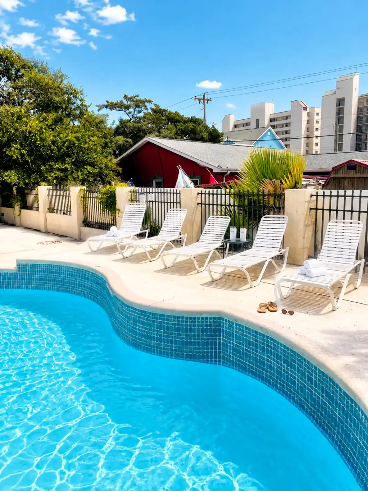 Inviting pool area with lounge chairs and a vibrant backdrop