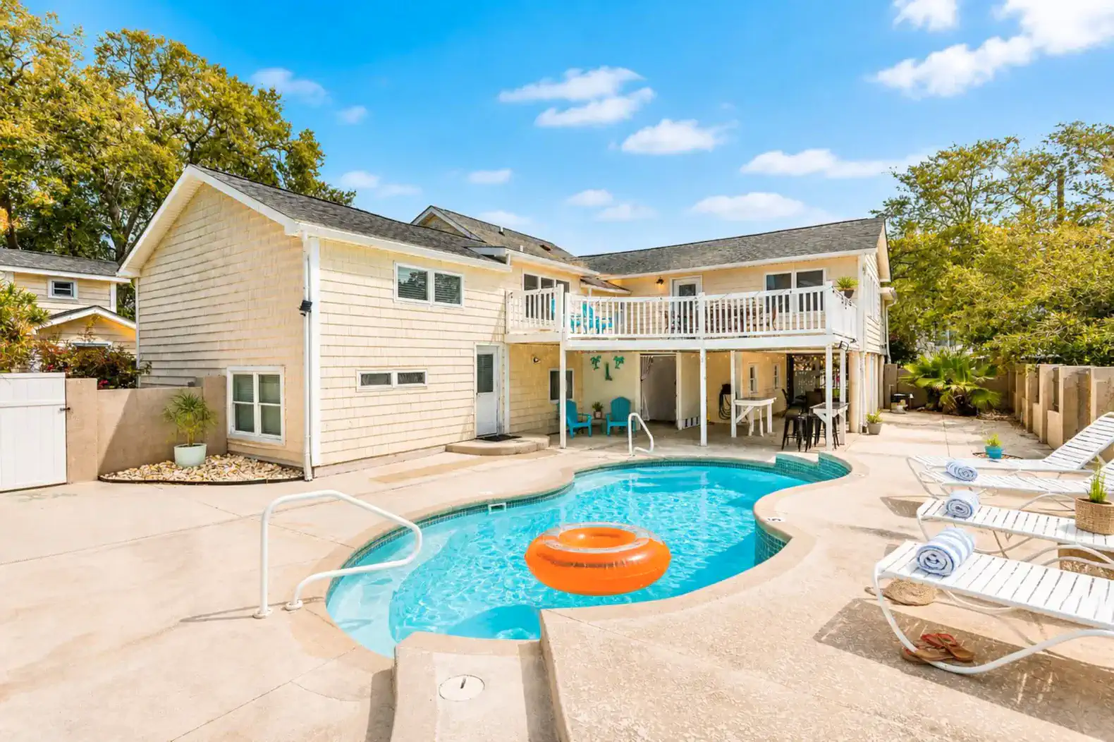 Inviting pool area with lounge chairs and a bright orange float