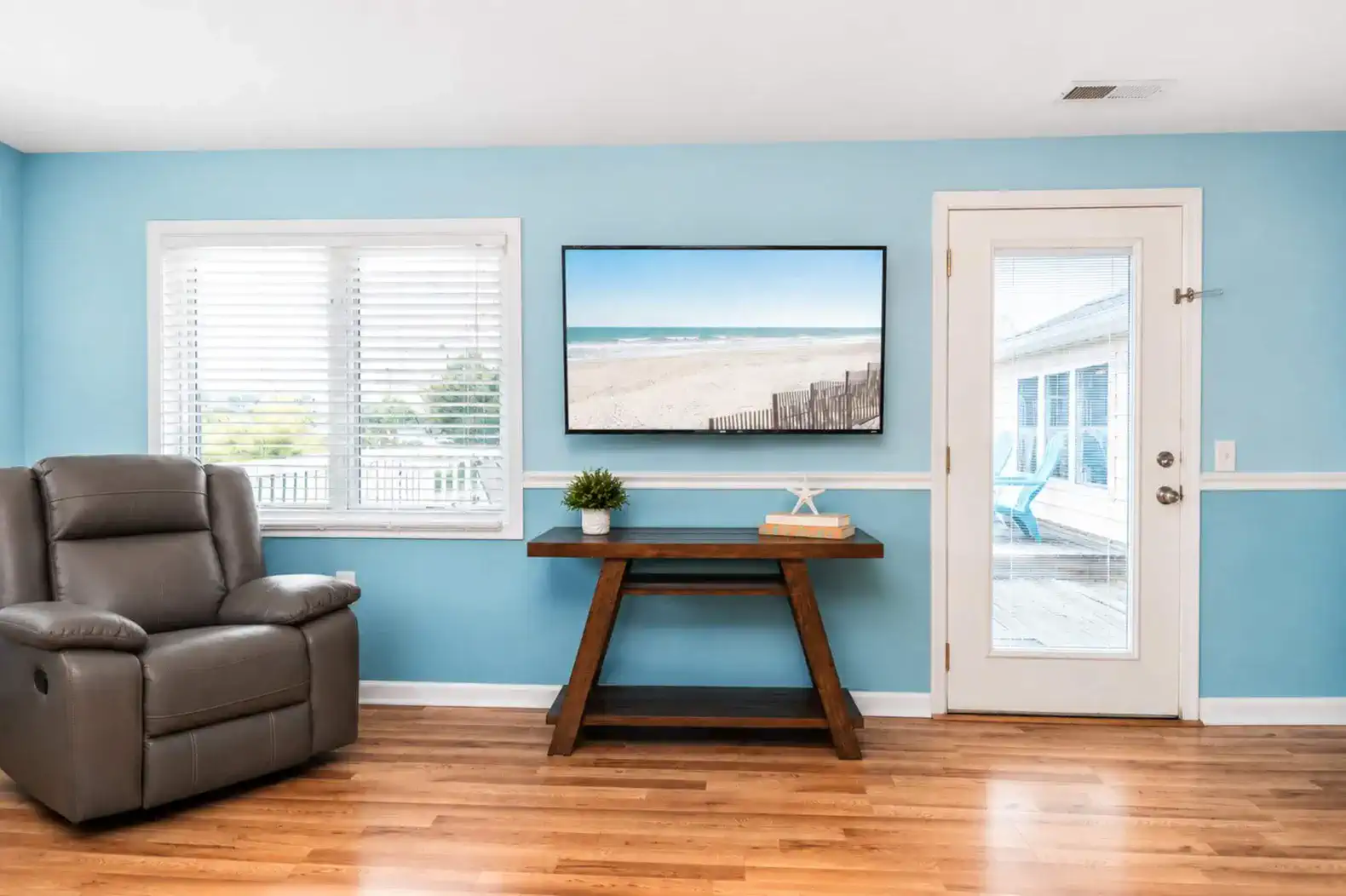 Large TV in Living Room.  Door on left goes to the deck overlooking the pool.