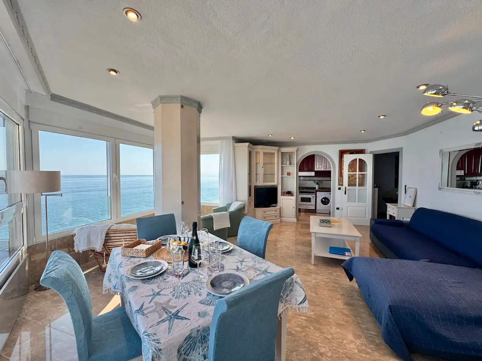 Bright living area with dining table and ocean views