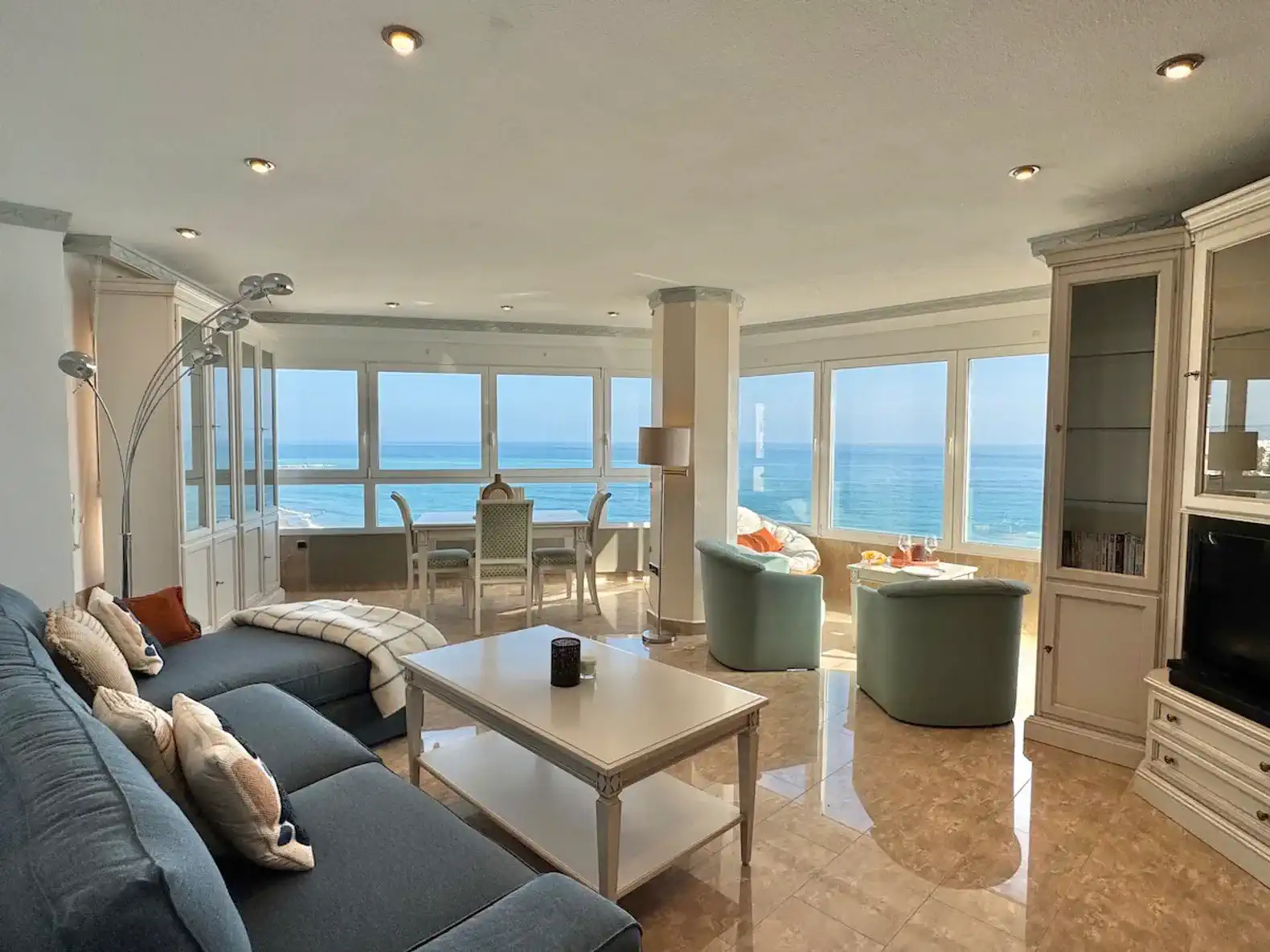 Bright living room with panoramic sea views and comfortable seating