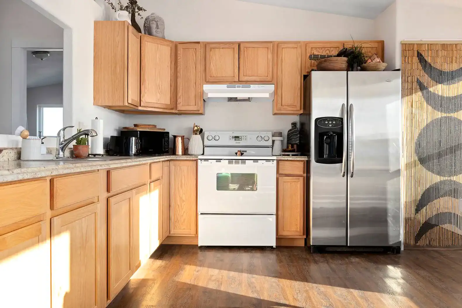 Bright kitchen with wooden cabinets, stainless steel appliances, and a cozy atmosphere