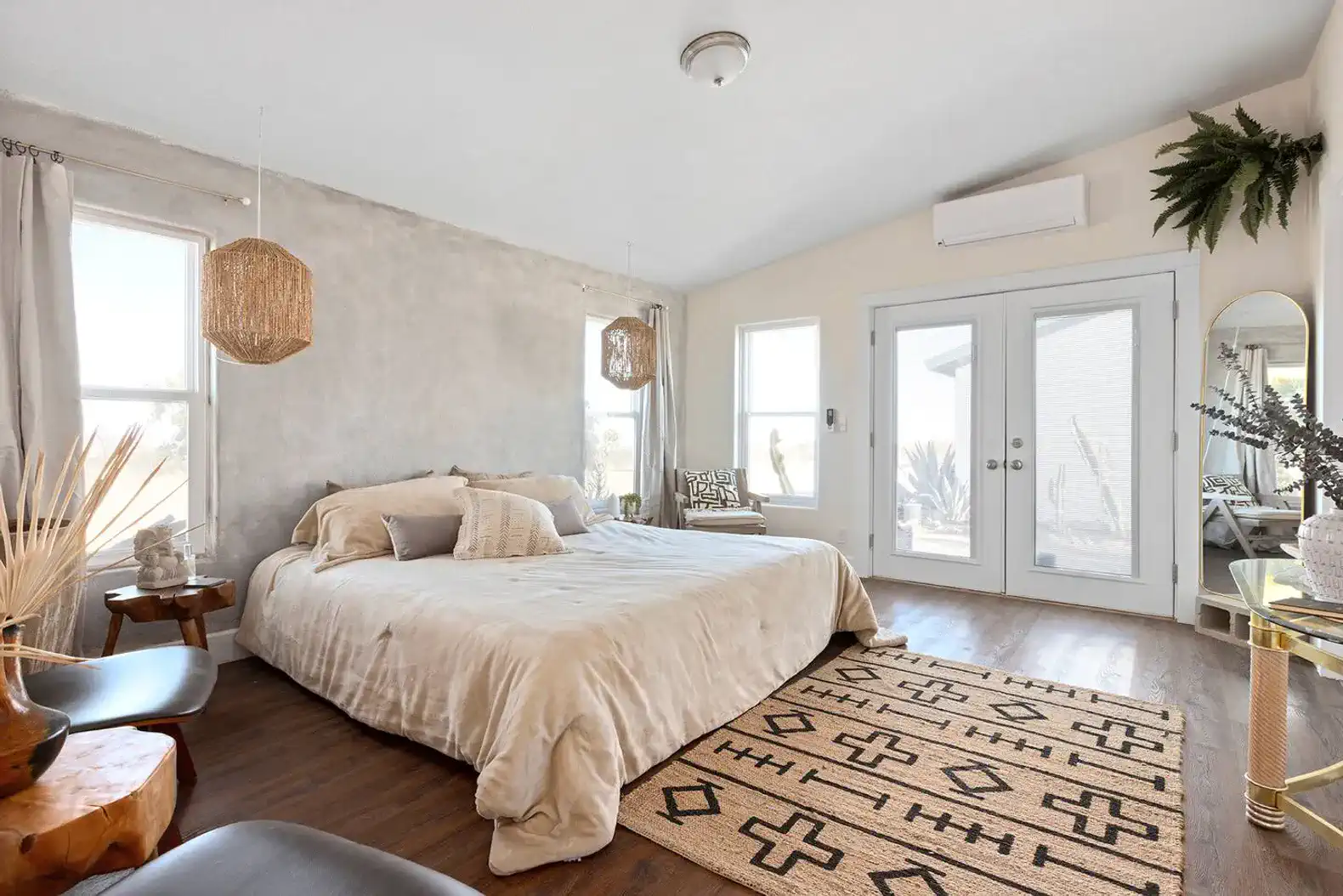 Primary bedroom with private attached bathroom and French doors to backyard.