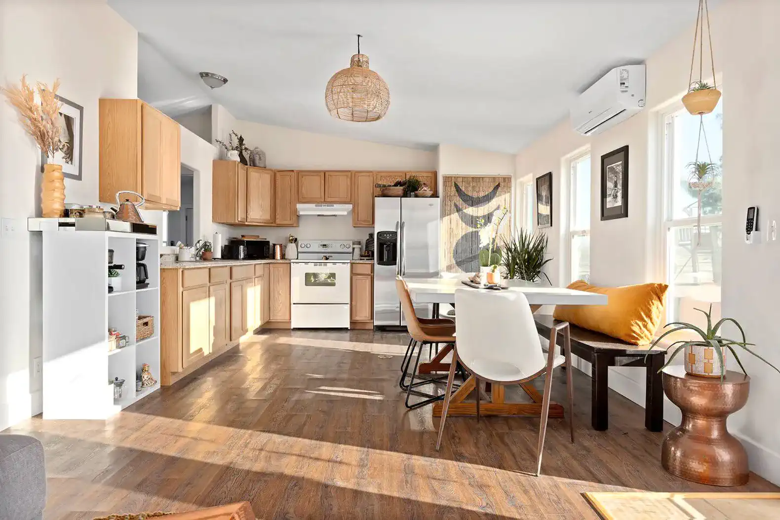 Bright kitchen with wooden cabinets, dining table, and modern decor