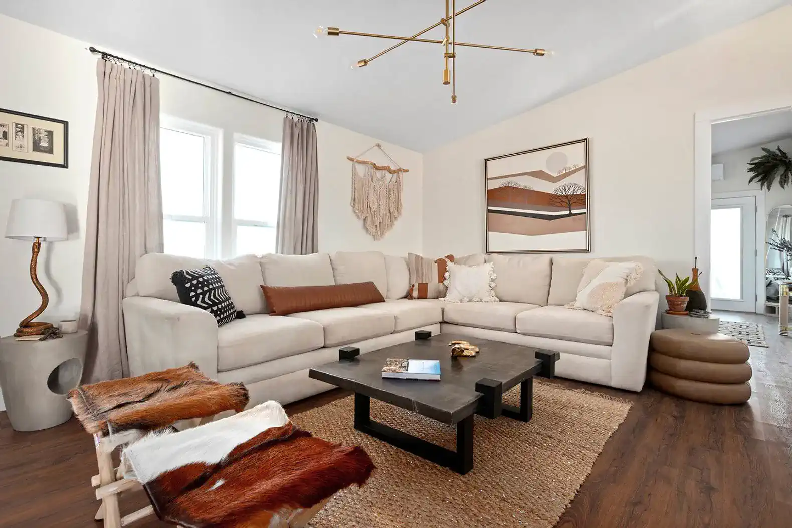 Cozy living room with a large sectional sofa, modern decor, and natural light