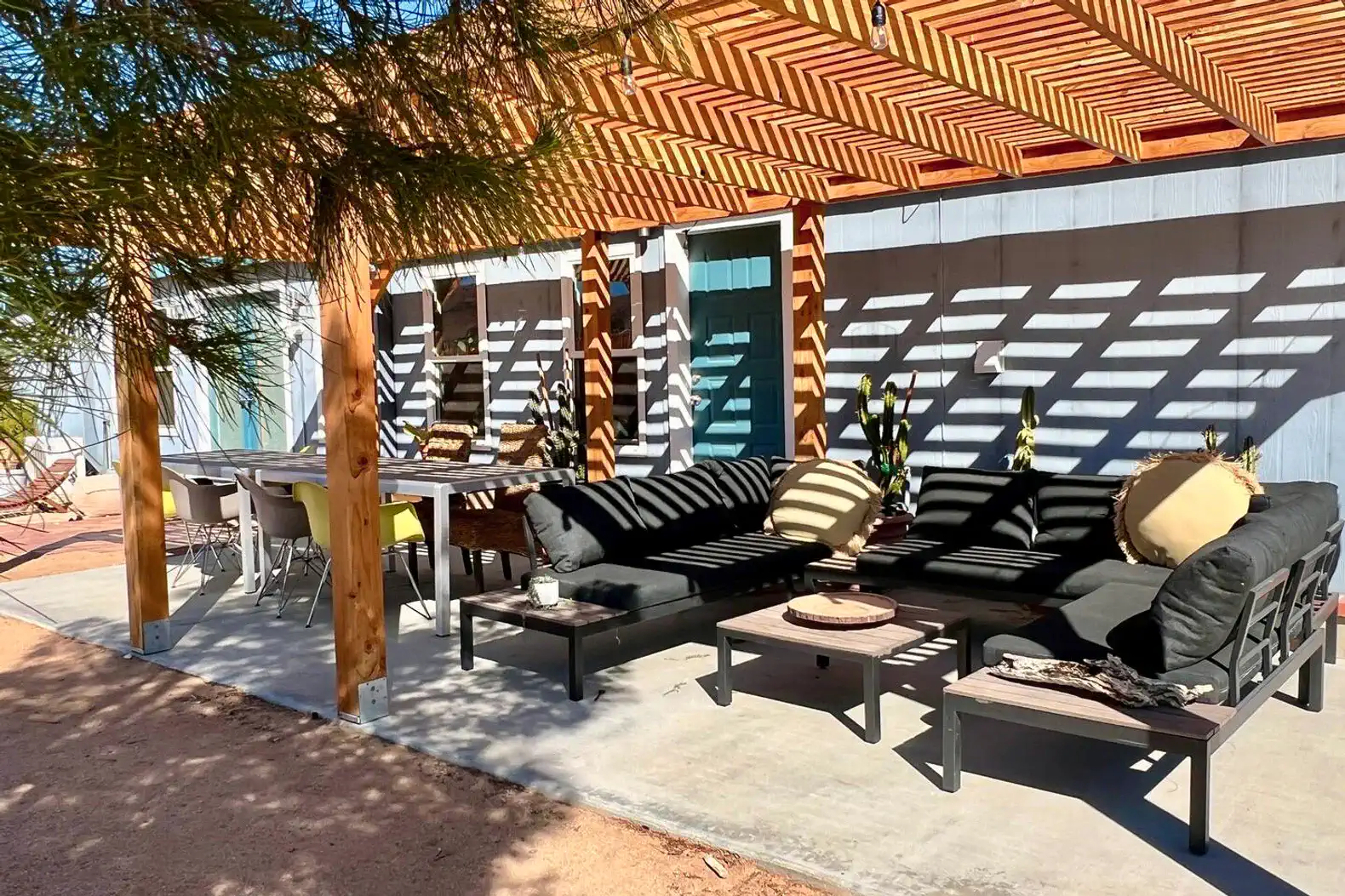 Shaded outdoor seating area with modern furniture and a dining table