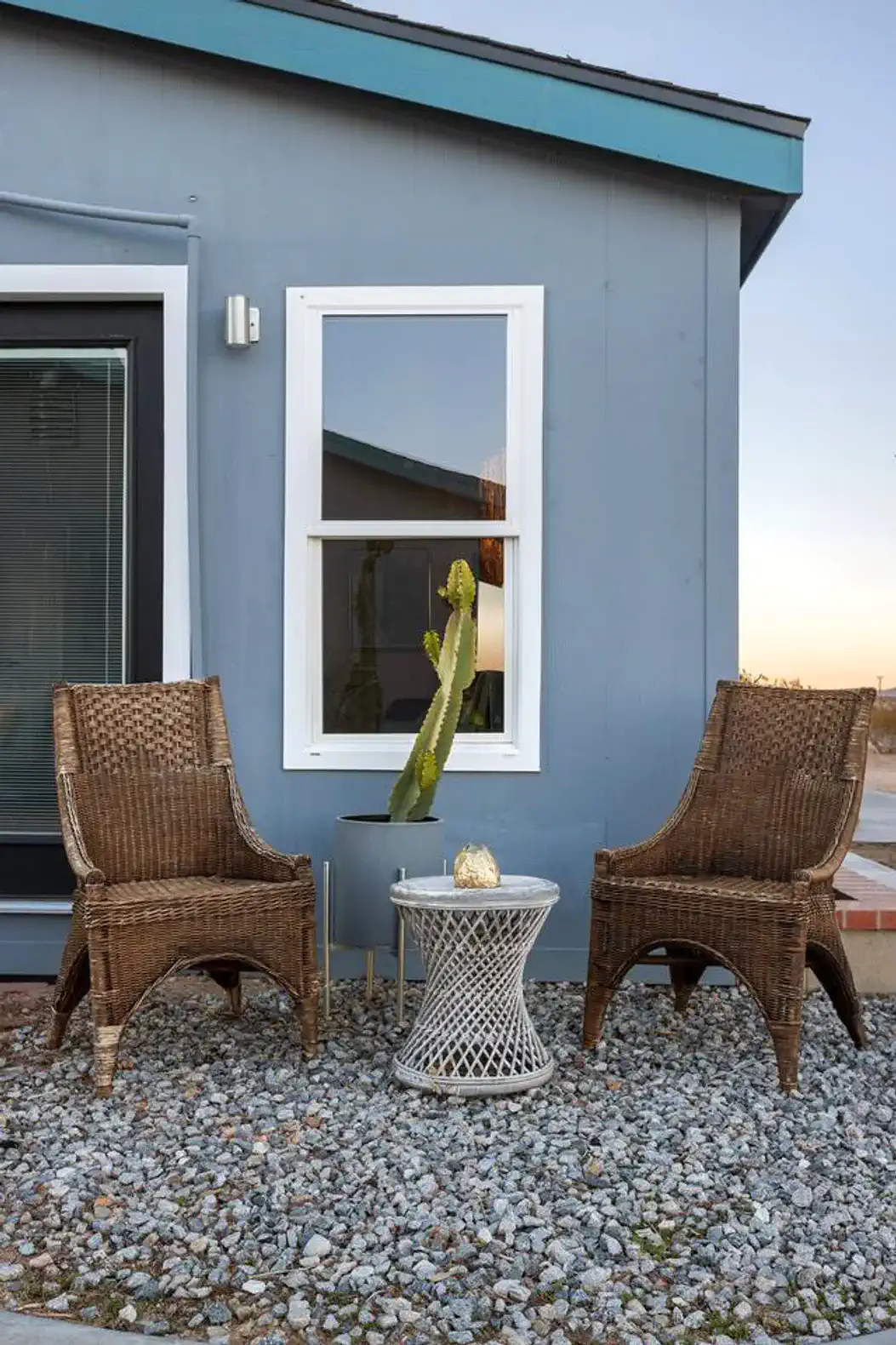 Cozy outdoor seating area with two wicker chairs and a small table
