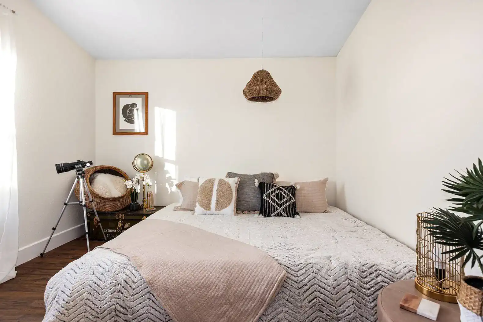 Cozy guest bedroom with a large bed, decorative pillows, and natural light