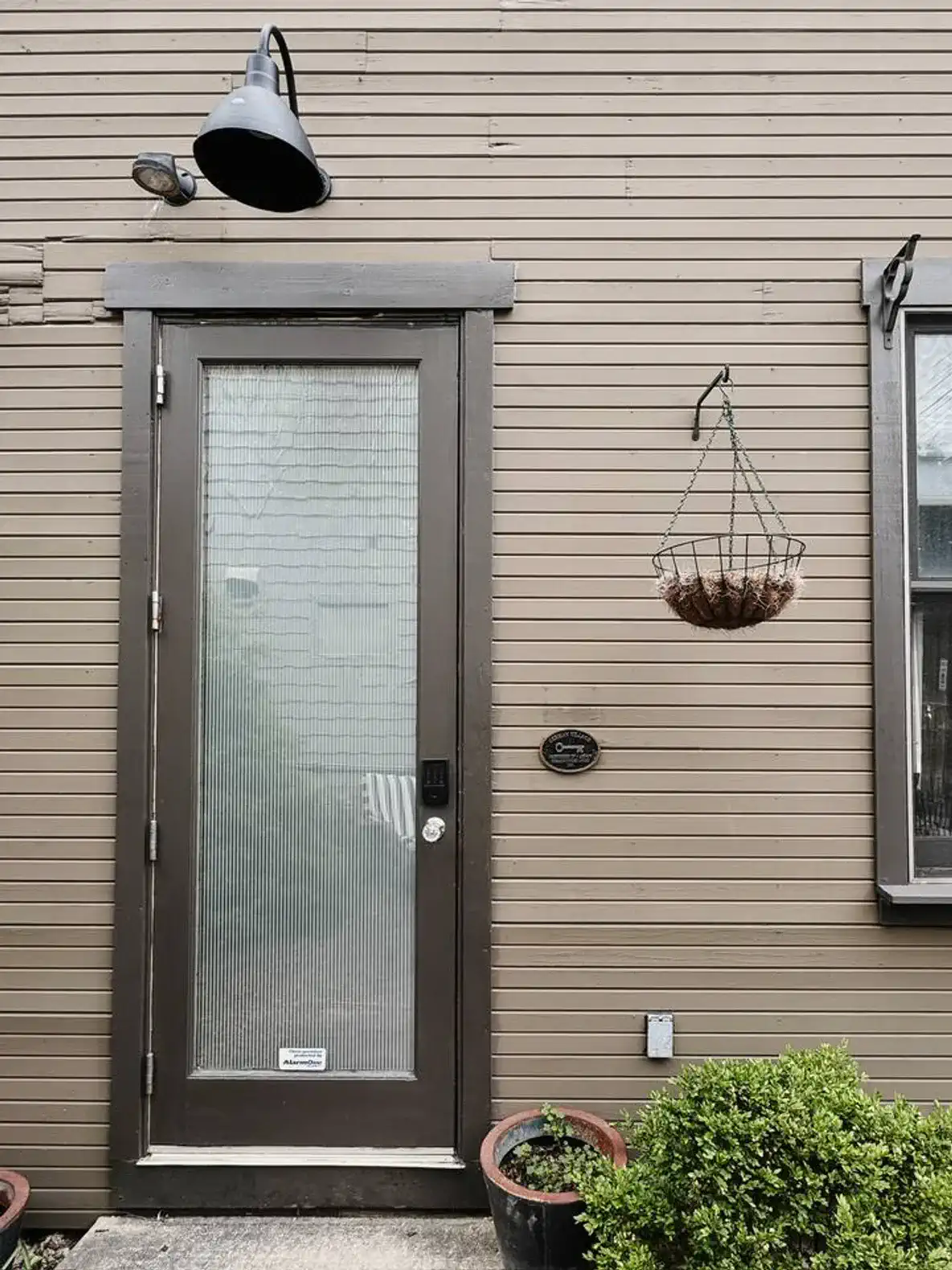 Charming entrance with a glass door and hanging plant basket