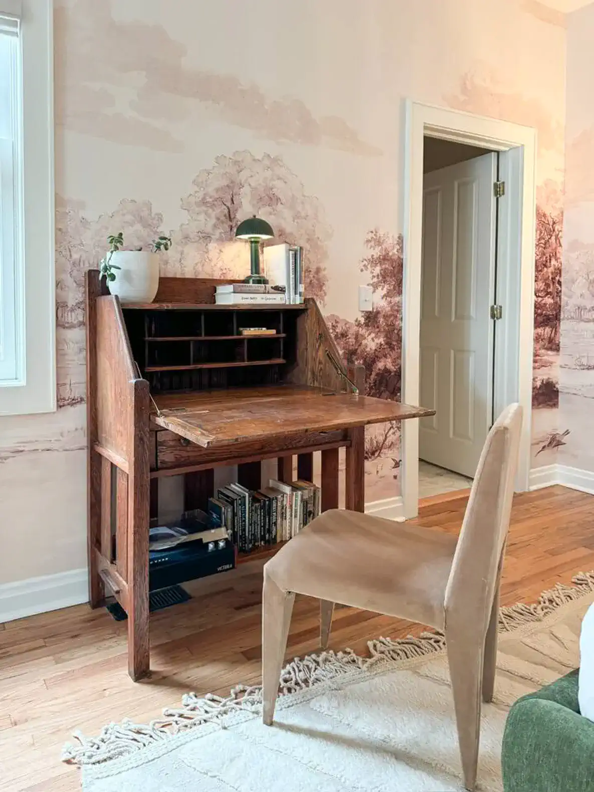 A small desk with a record player, and plenty of books to read.