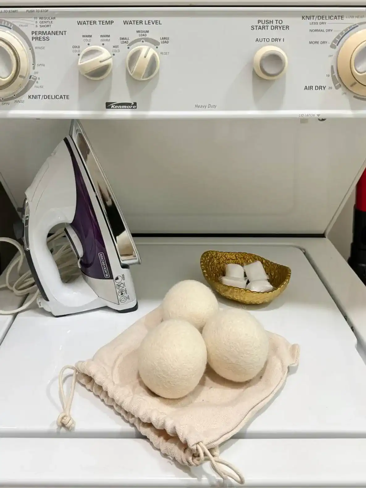 Iron, full ironing board, a few detergent pods to get started, and dryer balls for your laundry needs.
