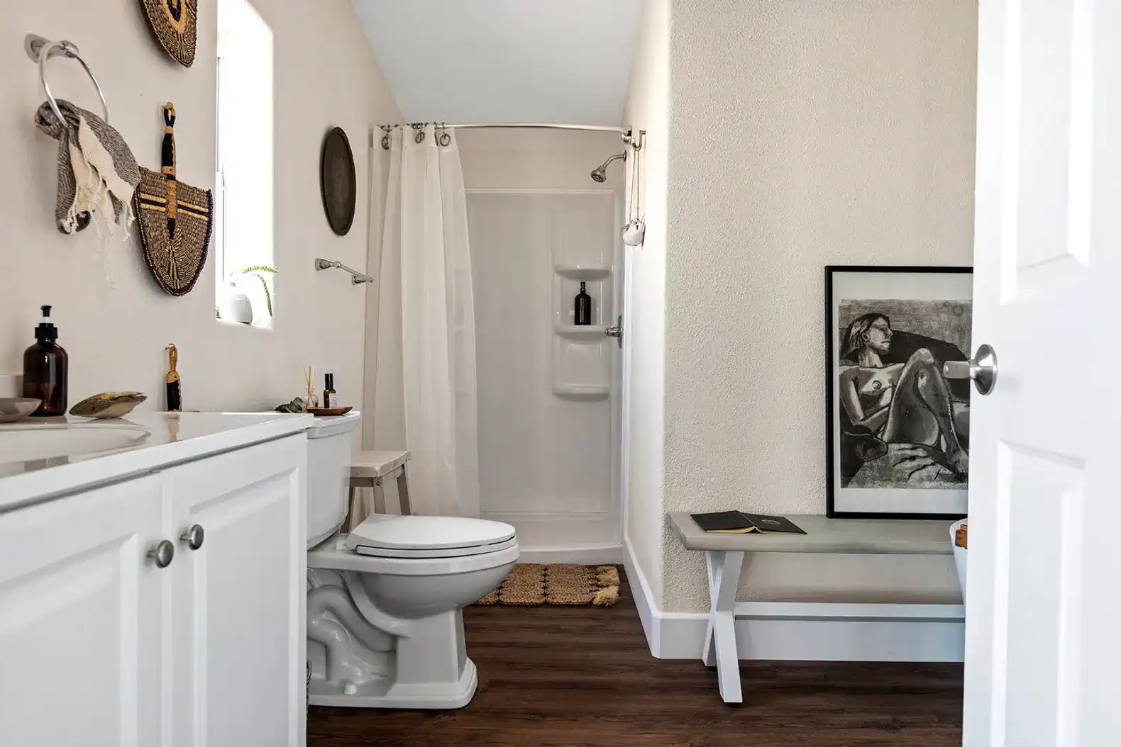 Modern bathroom featuring a shower, toilet, and decorative elements