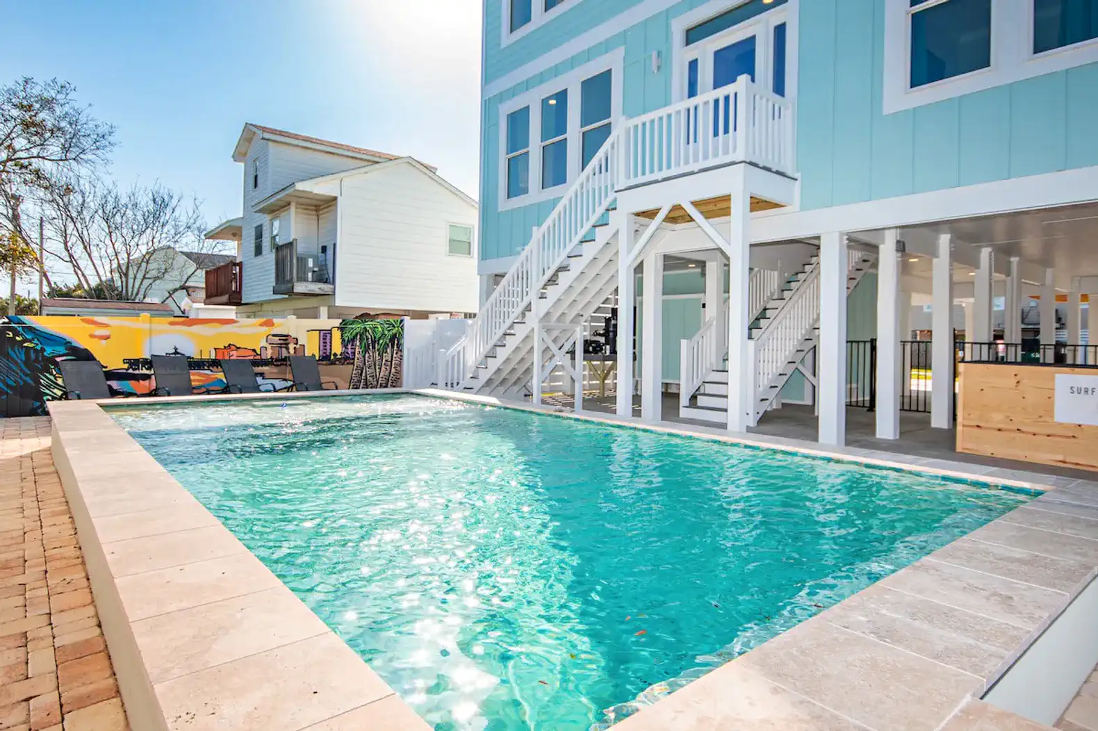 Sparkling pool surrounded by lounge chairs and outdoor seating area