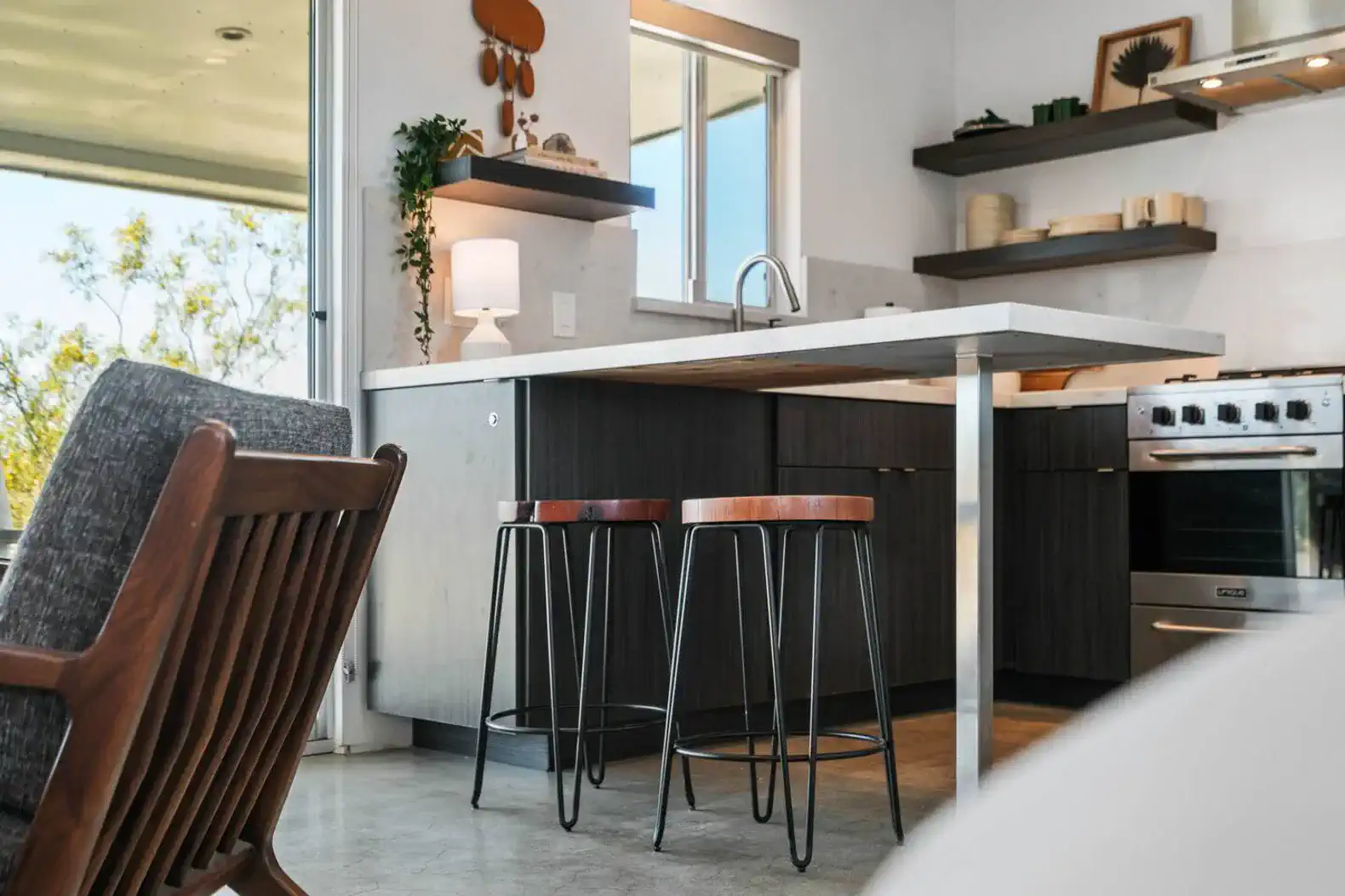 Modern kitchen with sleek countertops and stylish bar stools