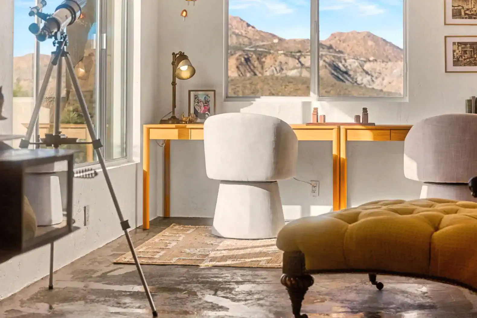 Stylish workspace with a view of desert mountains and modern furniture