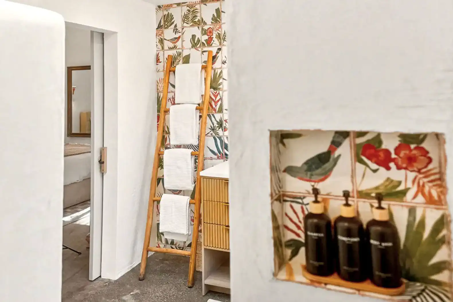 Stylish bathroom with tropical wallpaper and decorative storage for toiletries