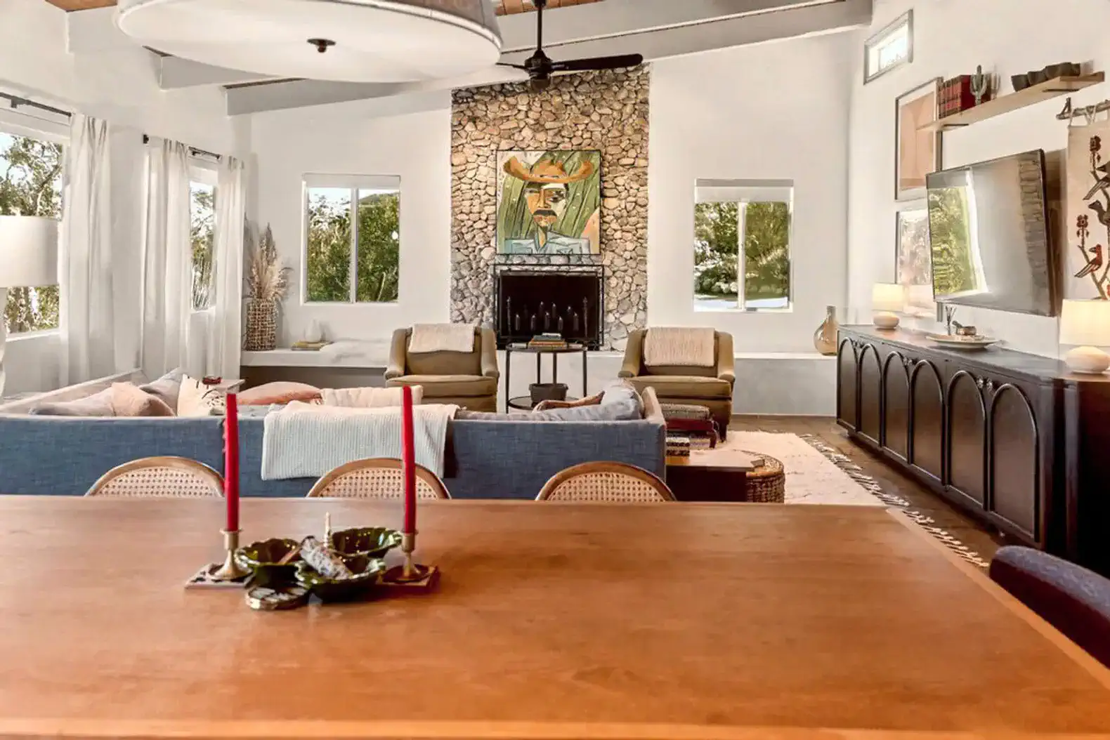 Spacious living room with stone fireplace and modern decor