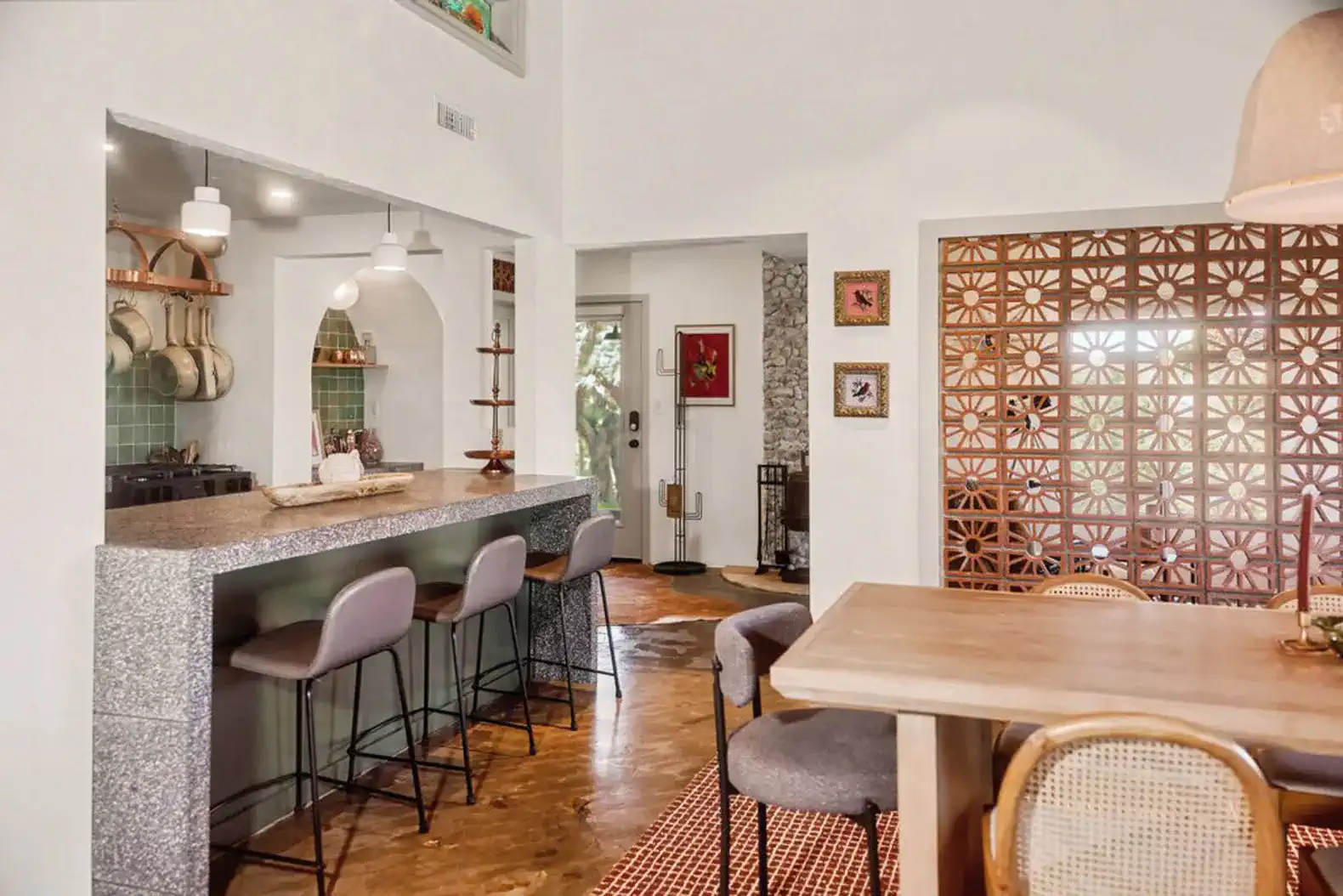 Stylish kitchen with bar seating and dining area featuring modern decor