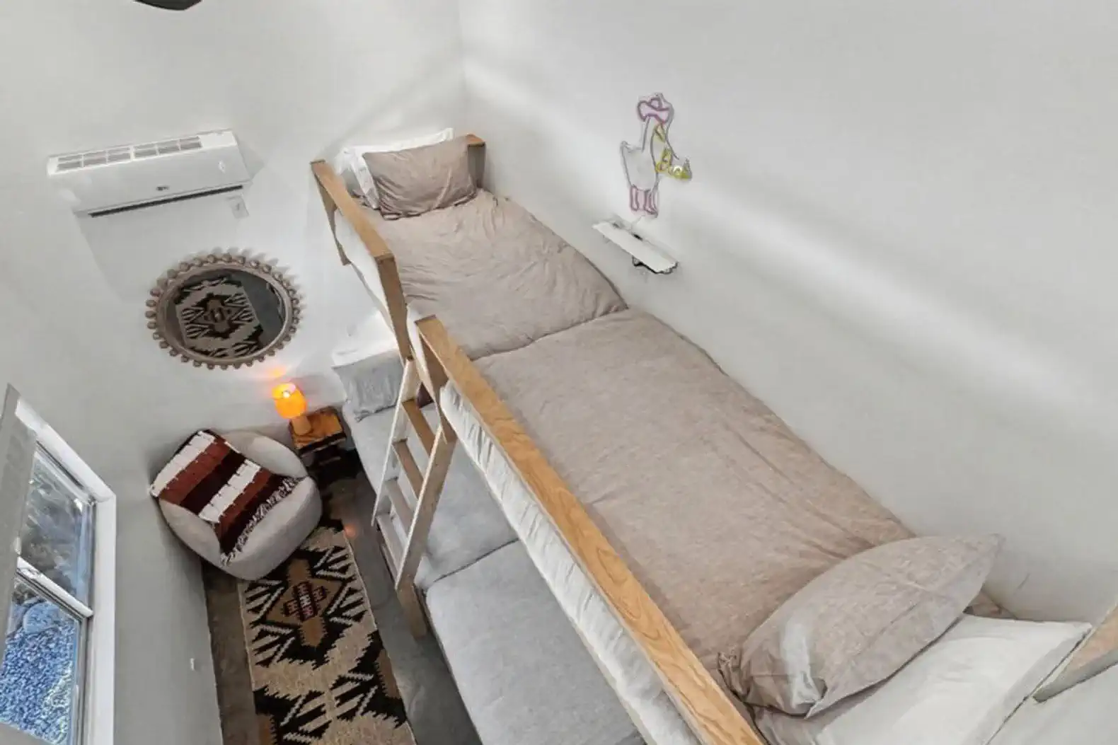 Cozy lofted sleeping area with two beds and decorative accents