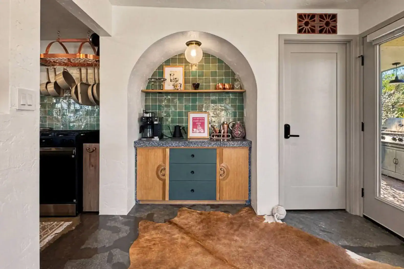 Charming kitchen nook with colorful tiles, wooden cabinetry, and a cozy rug