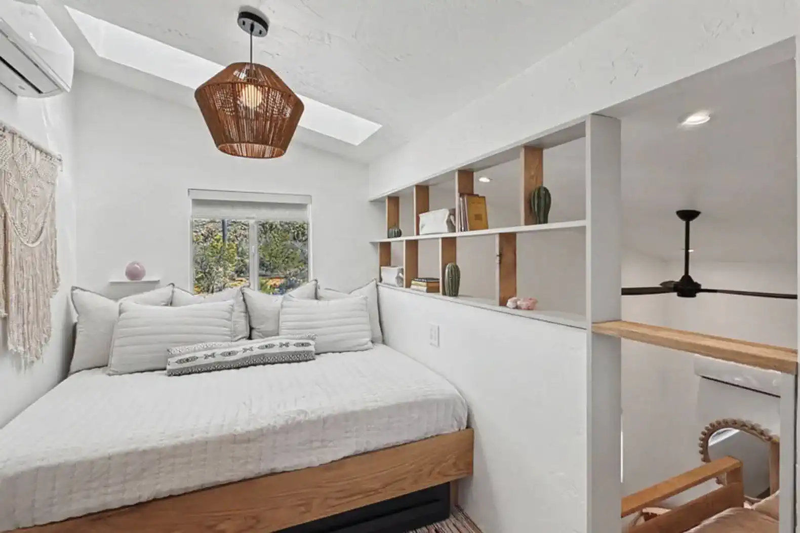 Cozy bedroom with a daybed, natural light, and decorative shelves