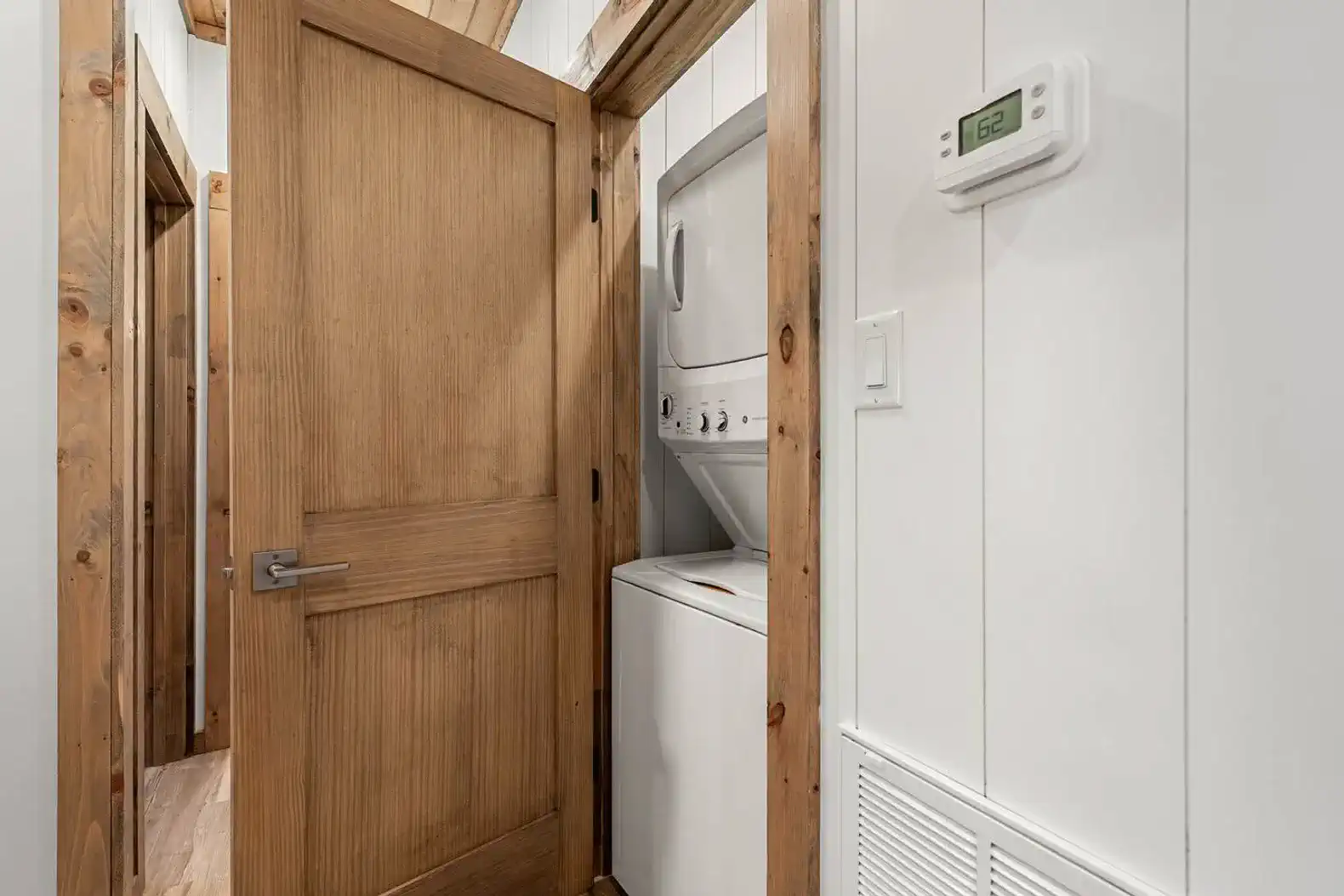 Laundry area with washer and dryer in a wooden hallway