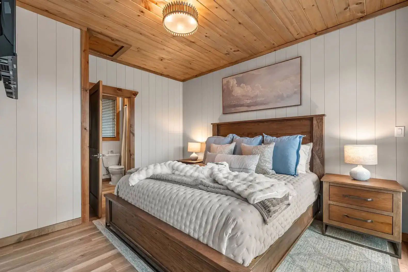 Cozy master bedroom with wooden accents and en-suite bathroom access
