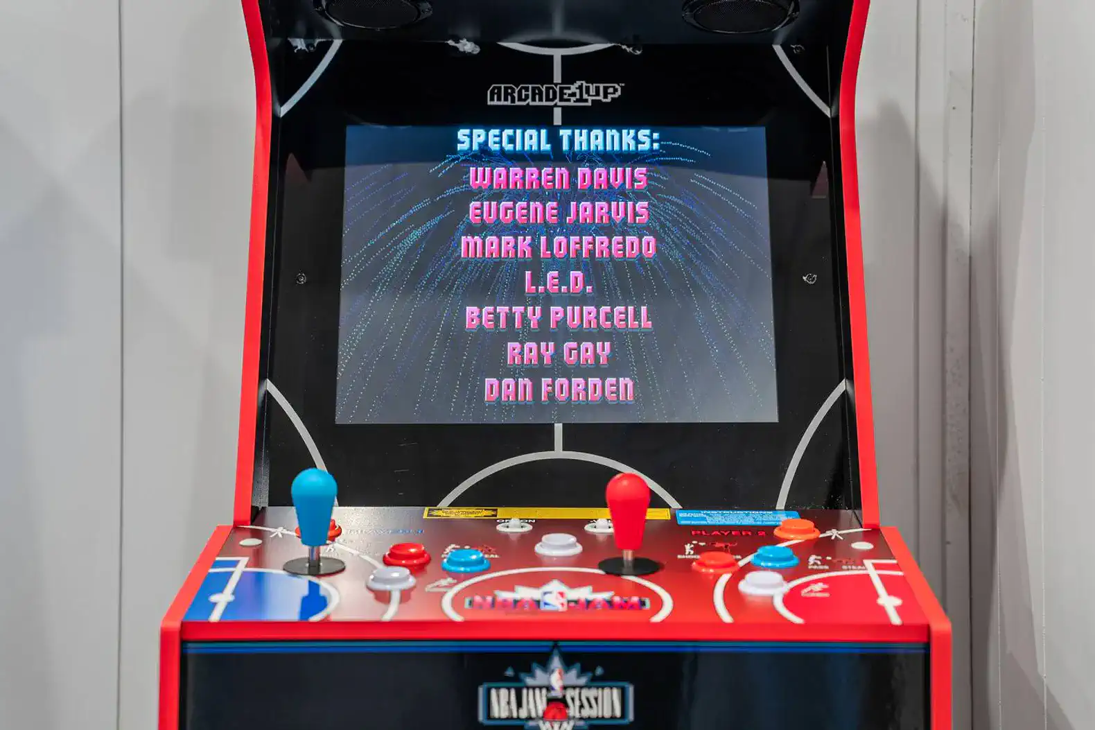 Colorful arcade game machine with joystick controls and a credits screen