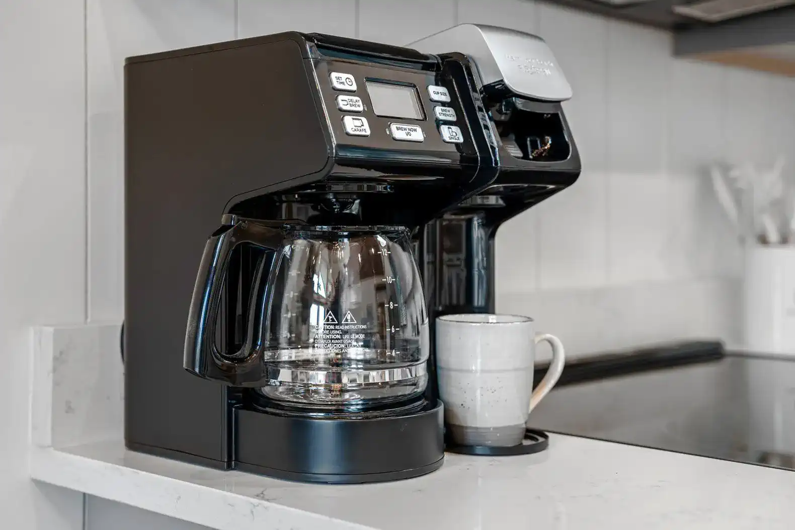 Coffee maker with a cup on a kitchen countertop