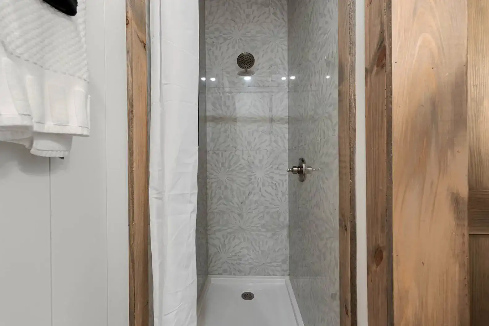 Modern shower with stylish tile and glass door