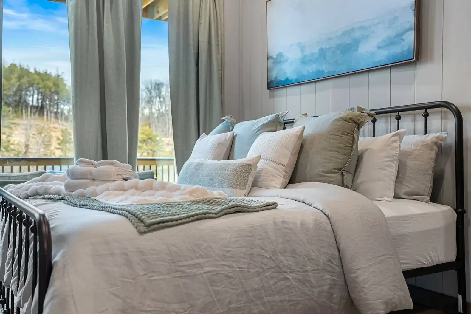 Cozy master bedroom with large windows and scenic views