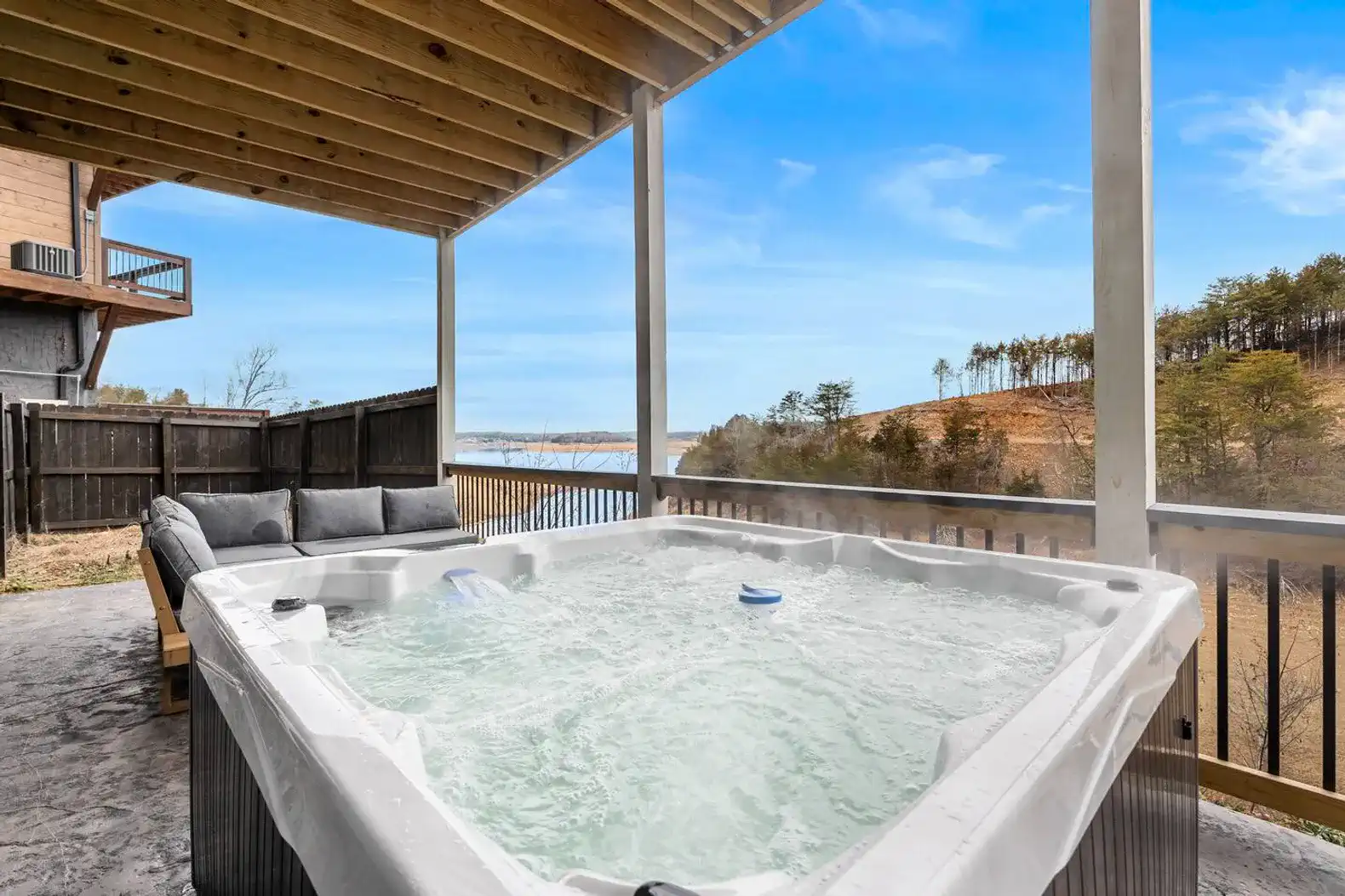 Relaxing hot tub with scenic lake views and outdoor seating
