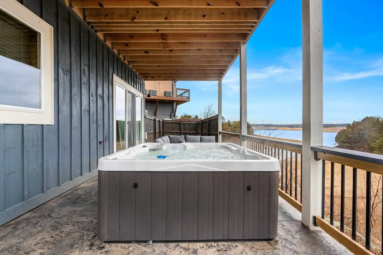 Hot tub on a covered deck with scenic lake views