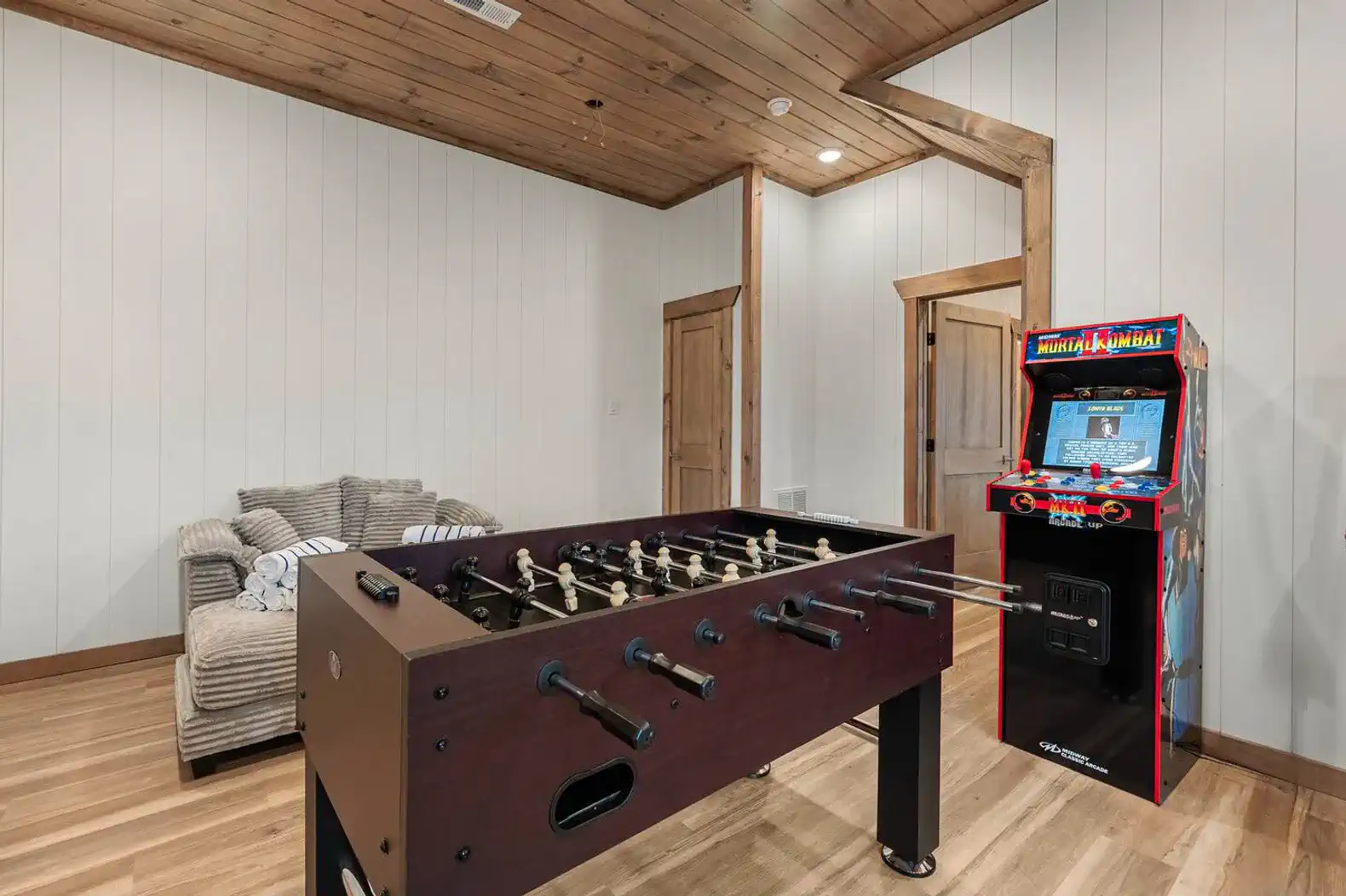 Game room featuring foosball table and arcade machine