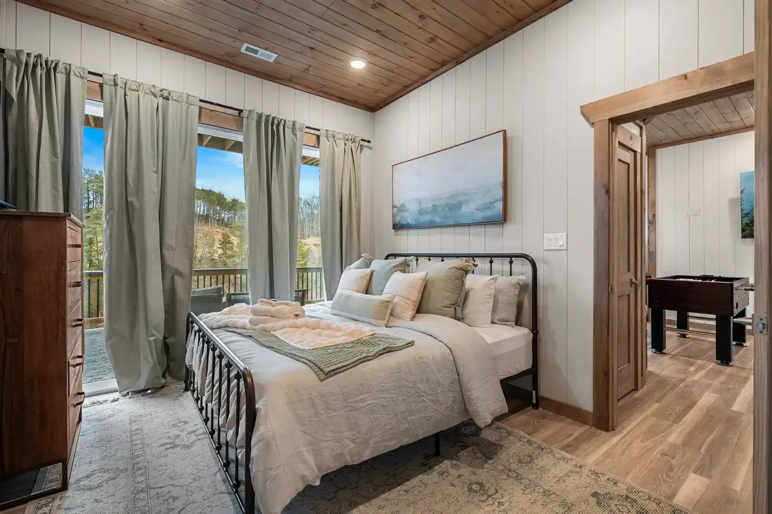 Cozy master bedroom with large windows and scenic views