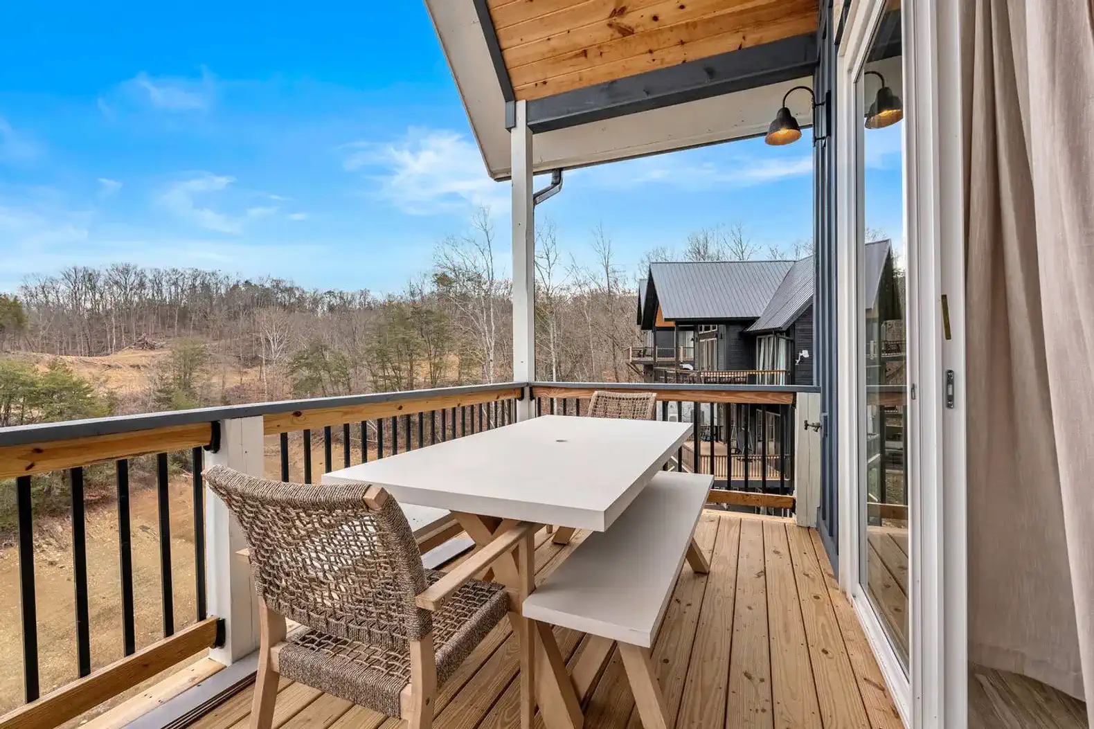 Outdoor dining area with a table and chairs overlooking scenic views