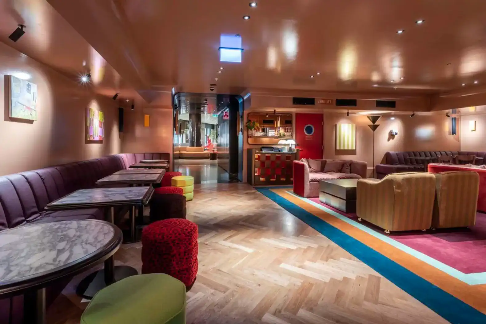 Stylish lounge area with colorful seating and marble tables