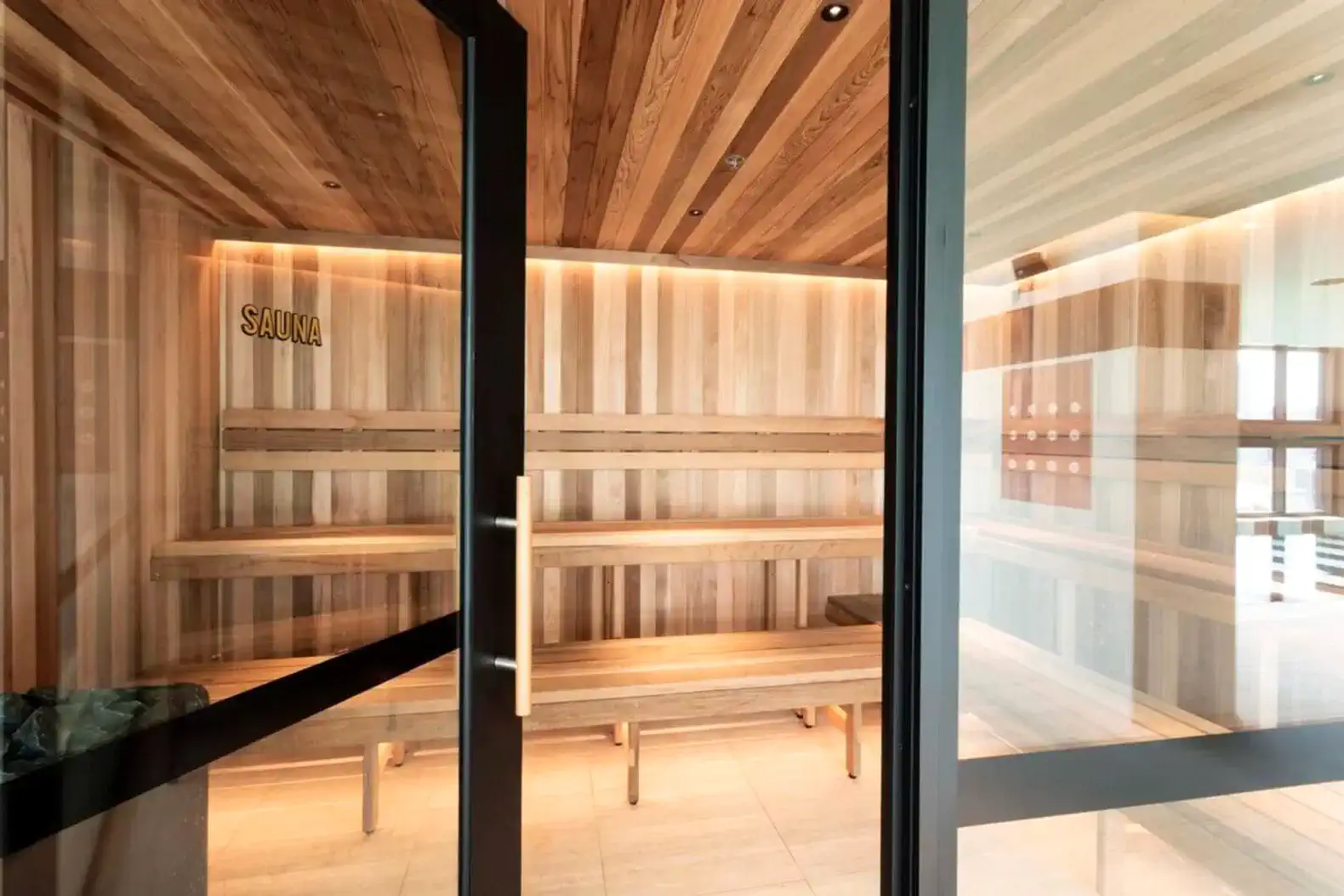 Wooden sauna with ambient lighting and benches