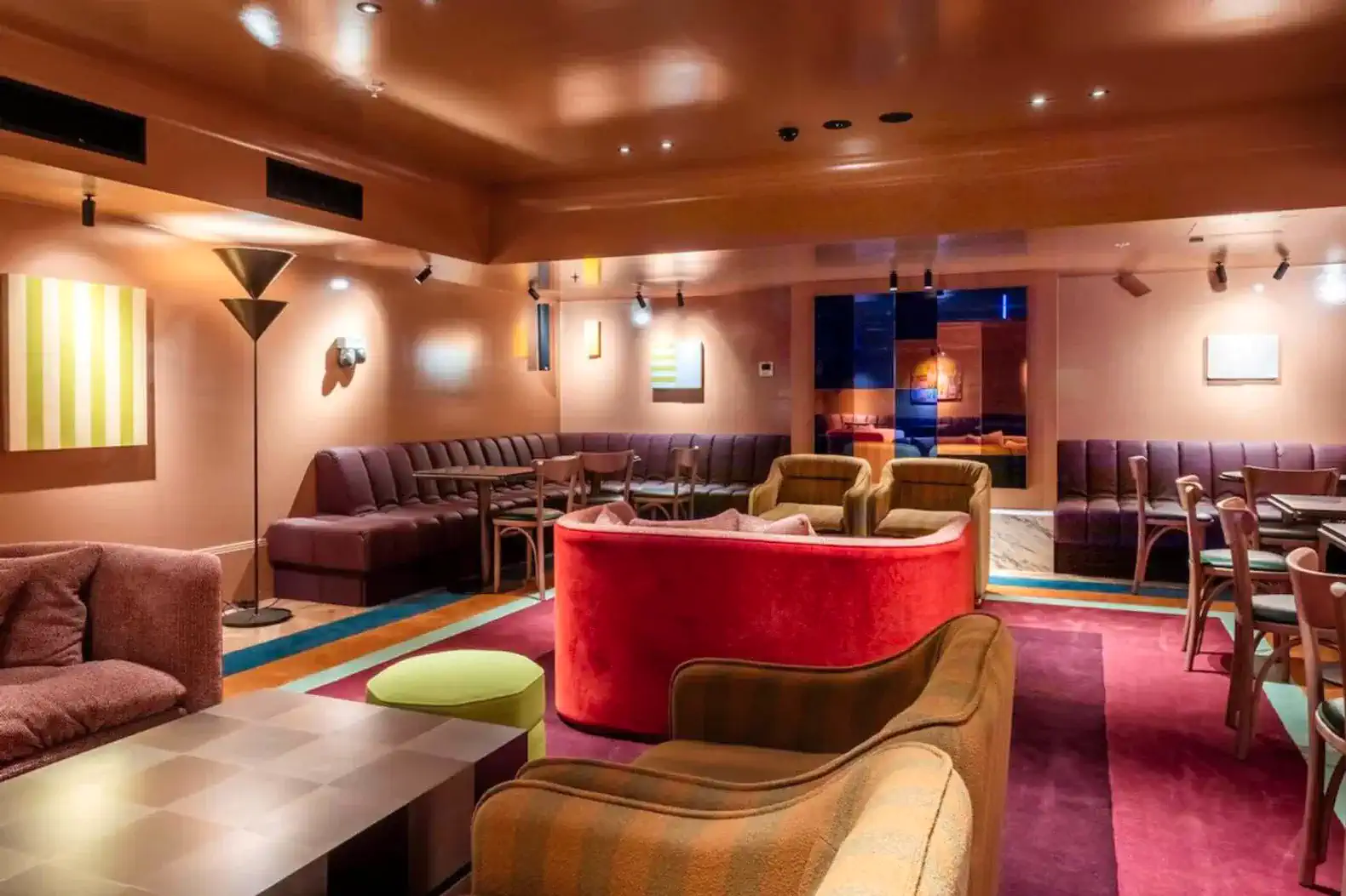 Stylish lounge area with colorful seating and modern artwork