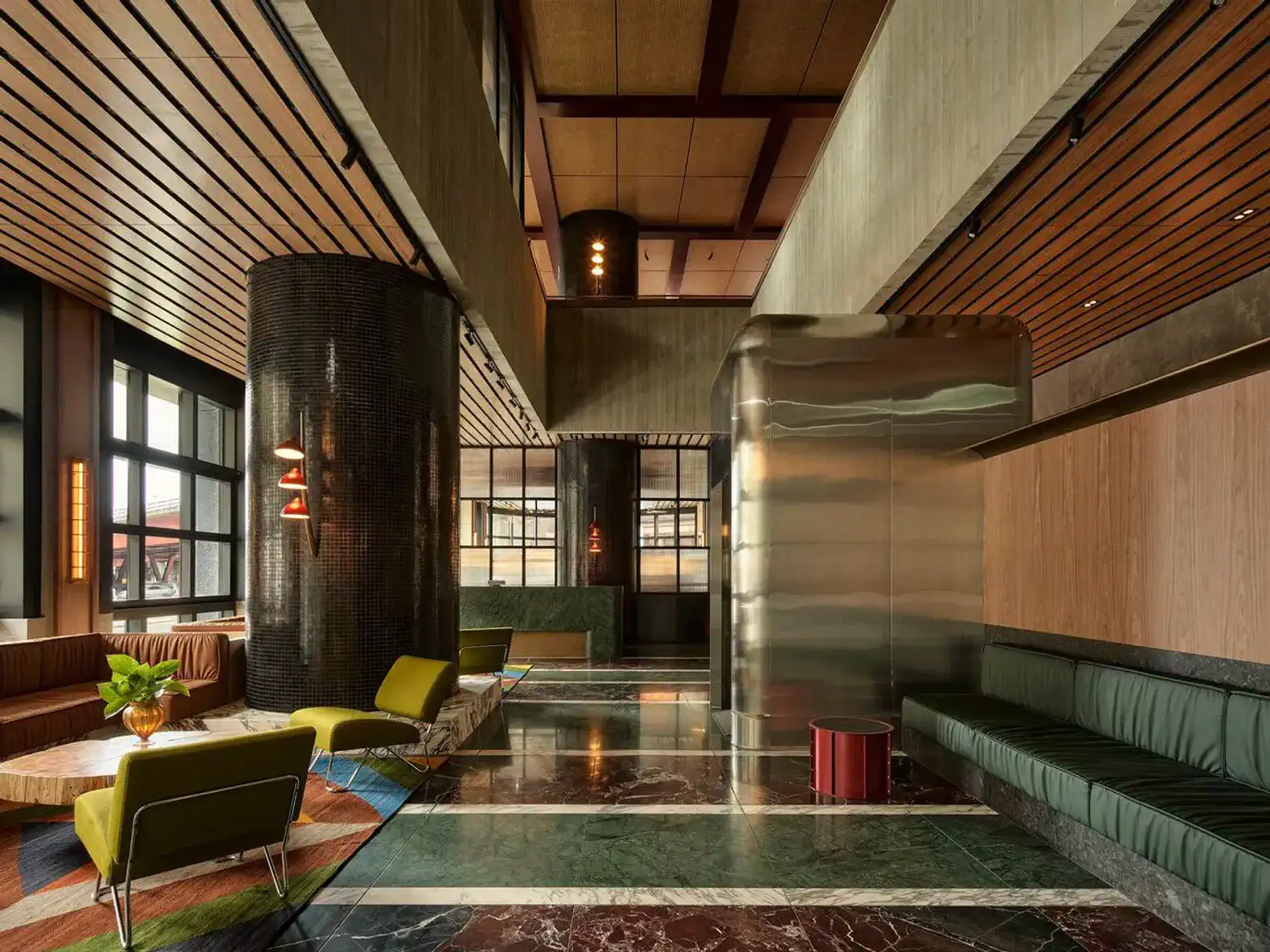 Stylish lobby with modern seating, marble flooring, and unique architectural features