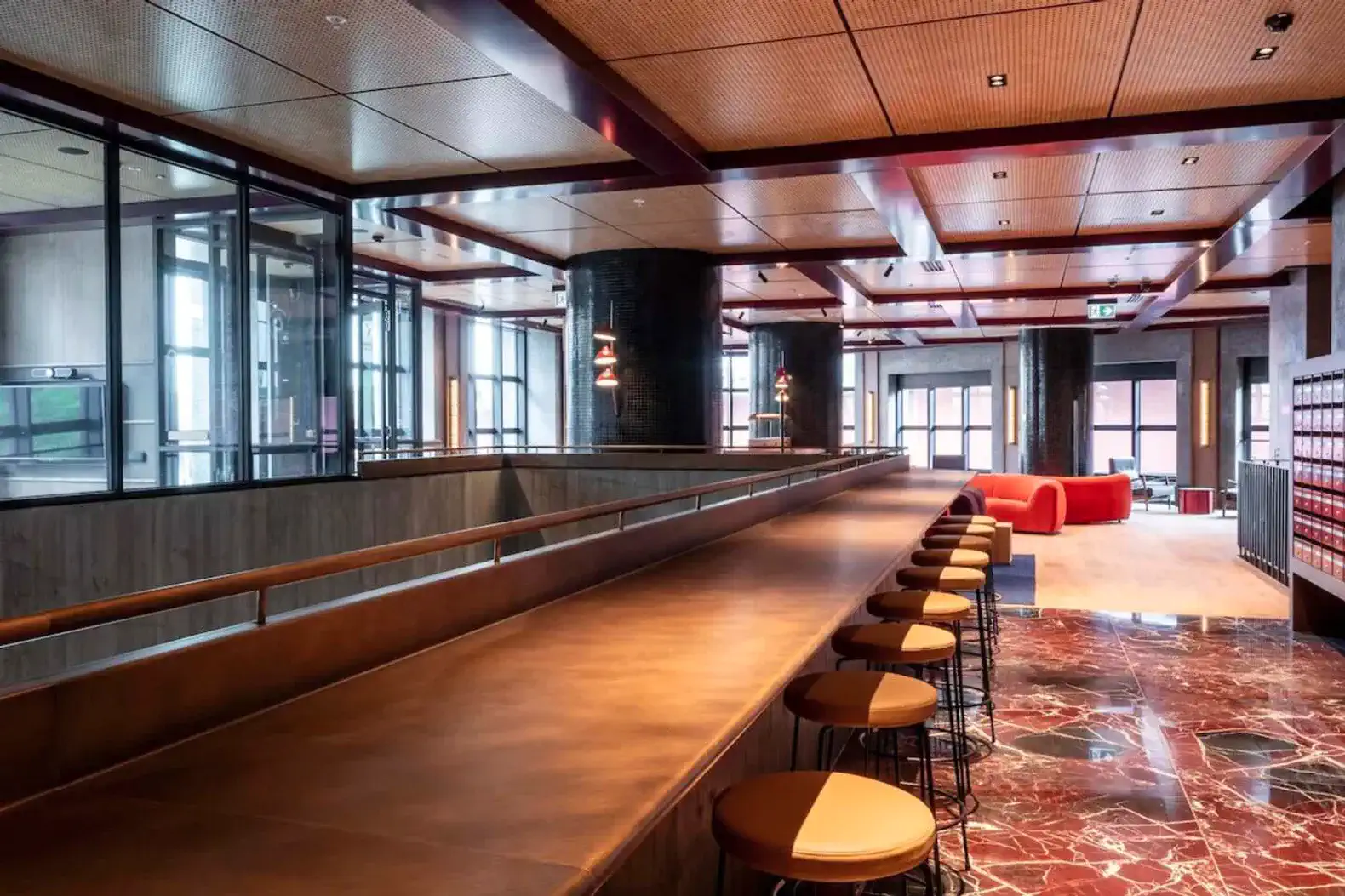 Stylish bar area with modern seating and marble flooring
